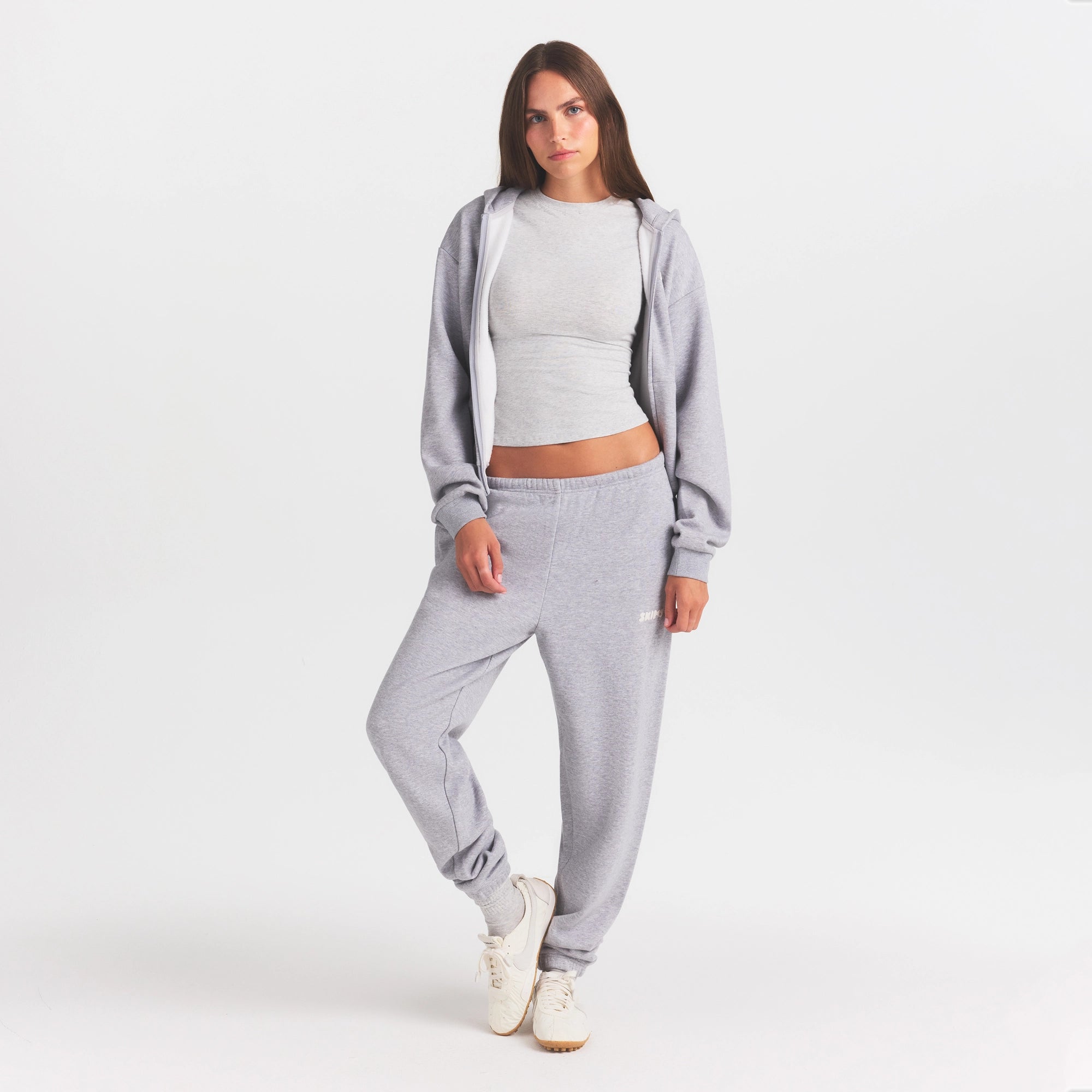 COTTON FLEECE JOGGER WITH EMBOSSED LOGO | HEATHER GREY ON A MODEL FRONT VIEW @ | FOCUS: 0.0, 1.0, 0.9