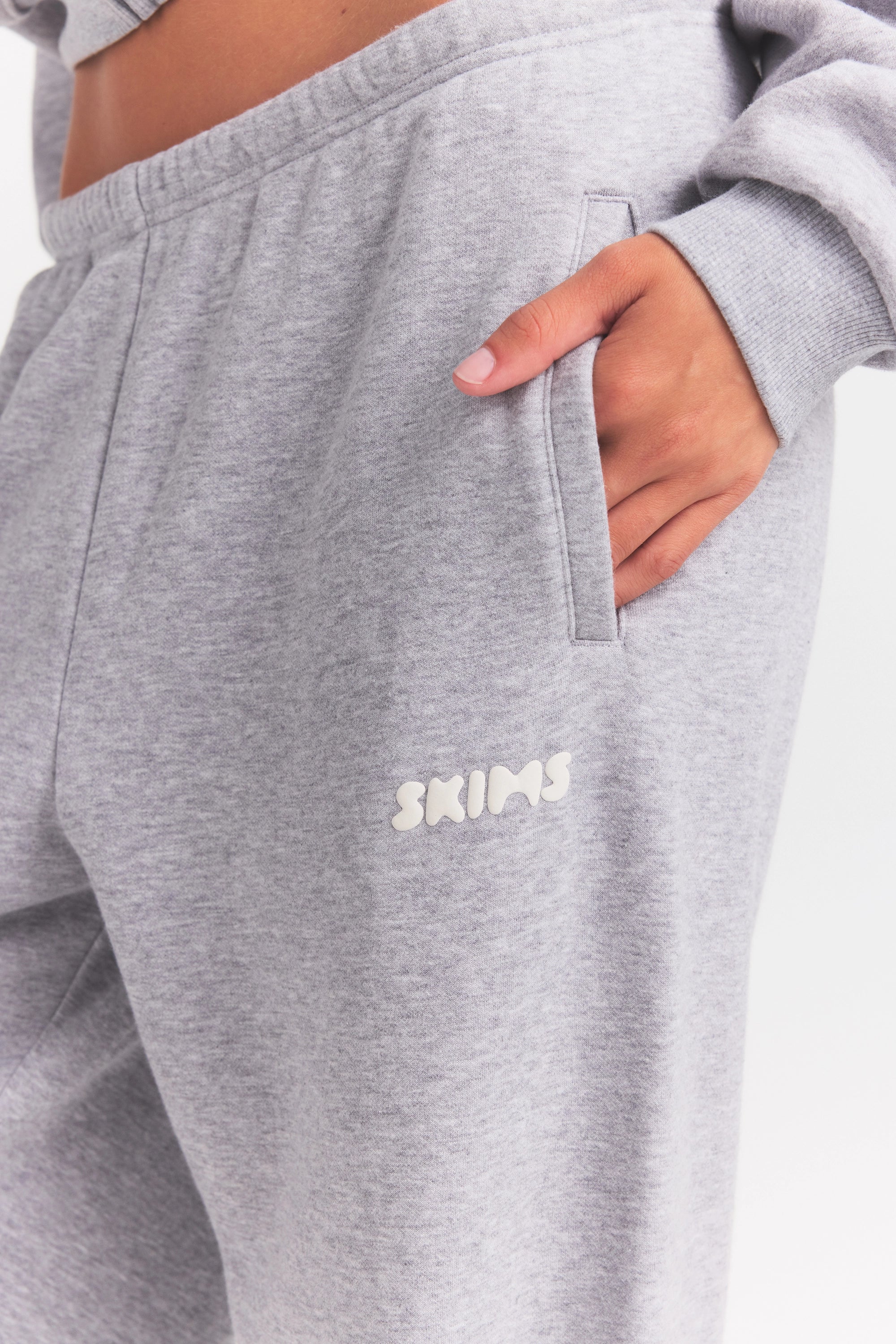 COTTON FLEECE JOGGER WITH EMBOSSED LOGO | HEATHER GREY ON A MODEL SIDE VIEW @ | FOCUS: 0.0, 1.0, 0.9