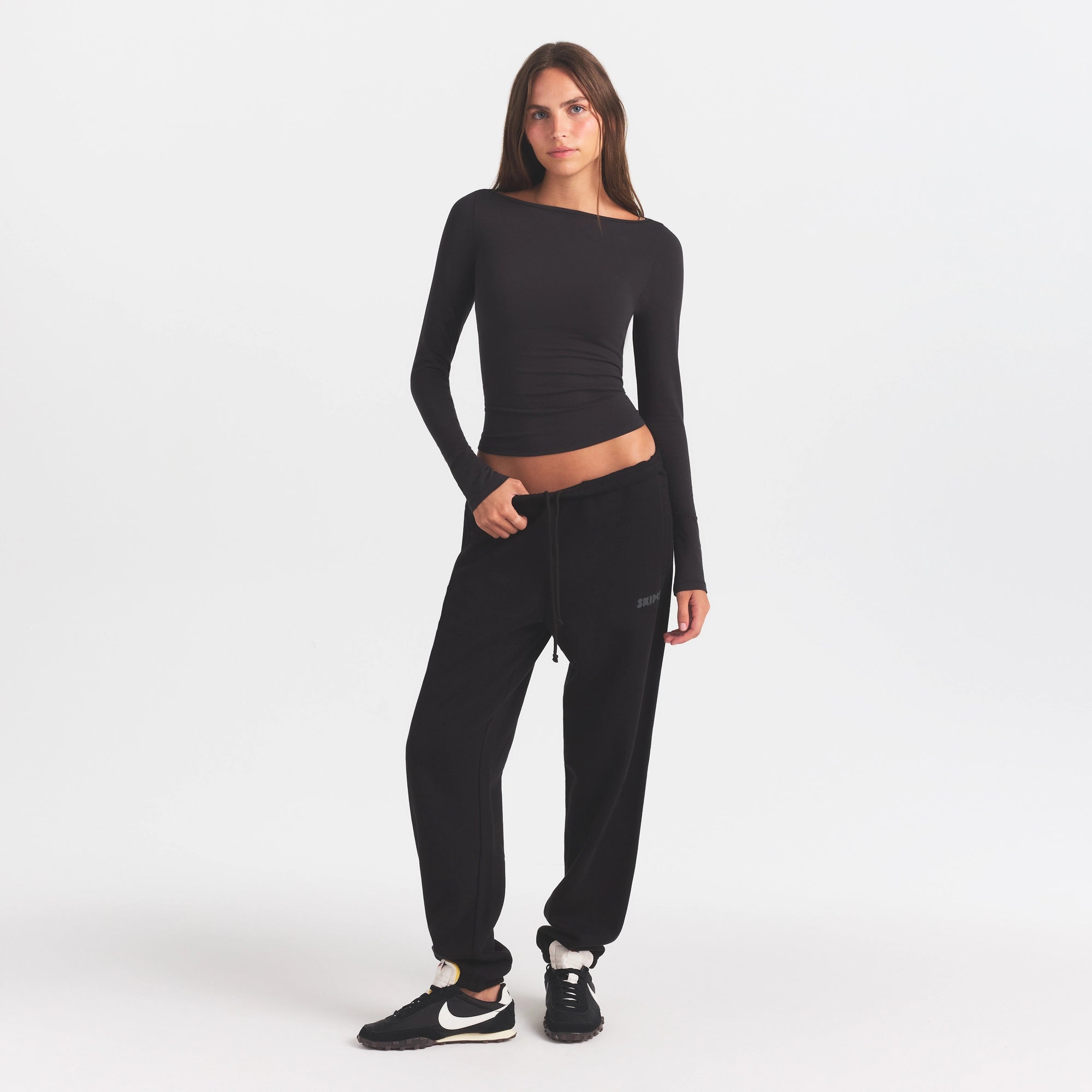 COTTON FLEECE JOGGER WITH EMBOSSED LOGO | ONYX & LAYS FLAT ON A WHITE BACKGROUND | FLT @ | FOCUS: 0.0, 1.0, 0.9