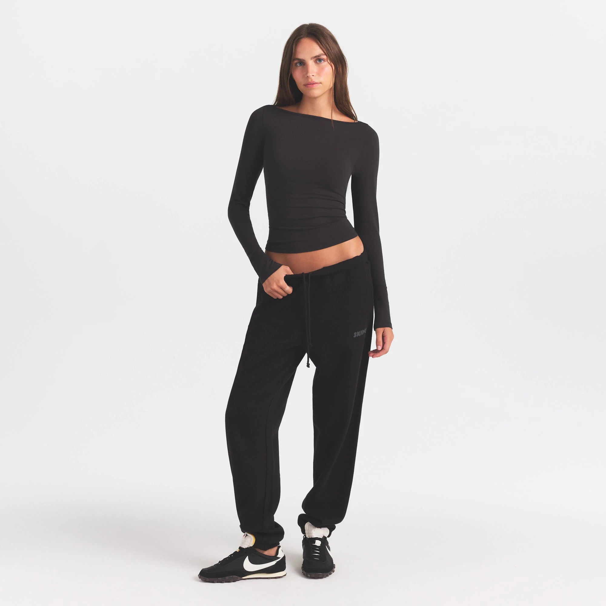 COTTON FLEECE JOGGER WITH EMBOSSED LOGO | ONYX & LAYS FLAT ON A WHITE BACKGROUND | FLT @ | FOCUS: 0.0, 1.0, 0.9