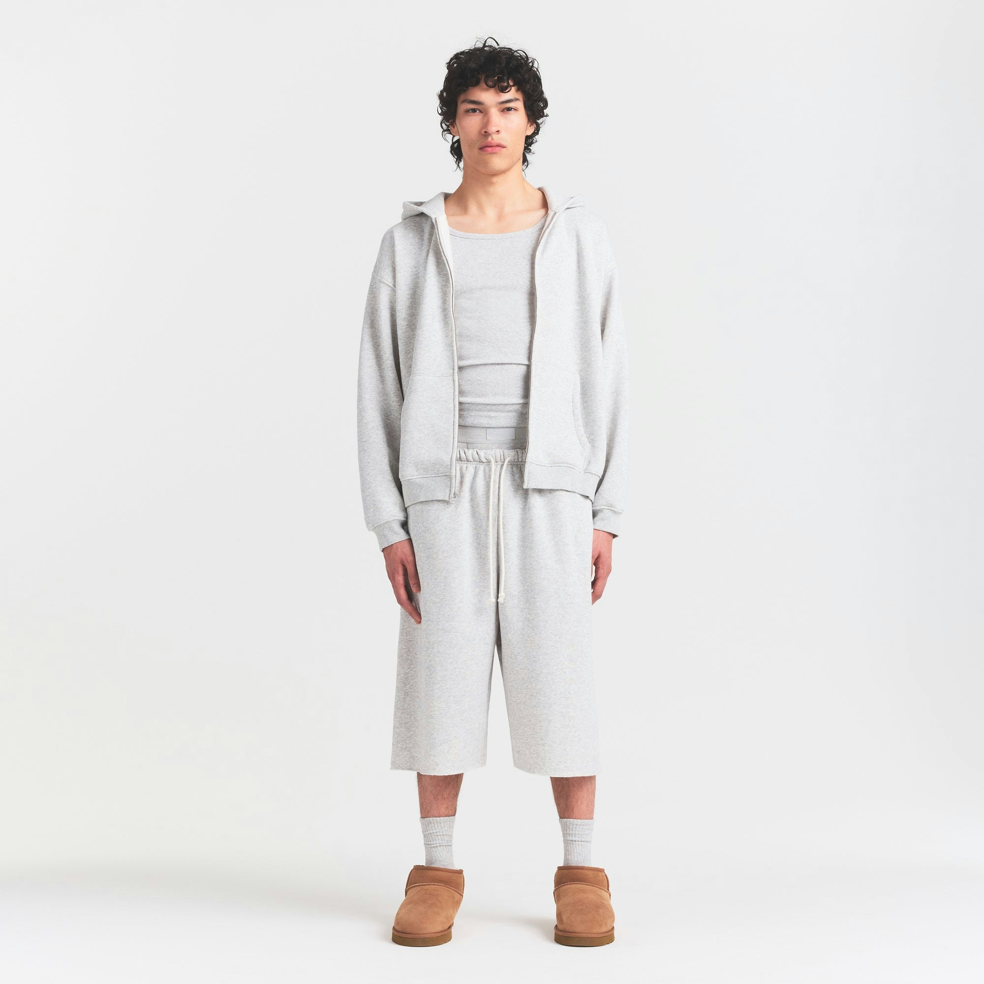 FLEECE LOUNGE MENS RELAXED LONG SHORT | LIGHT HEATHER GREY ON A MODEL FRONT VIEW @ | FOCUS: 0.0, 1.0, 0.9