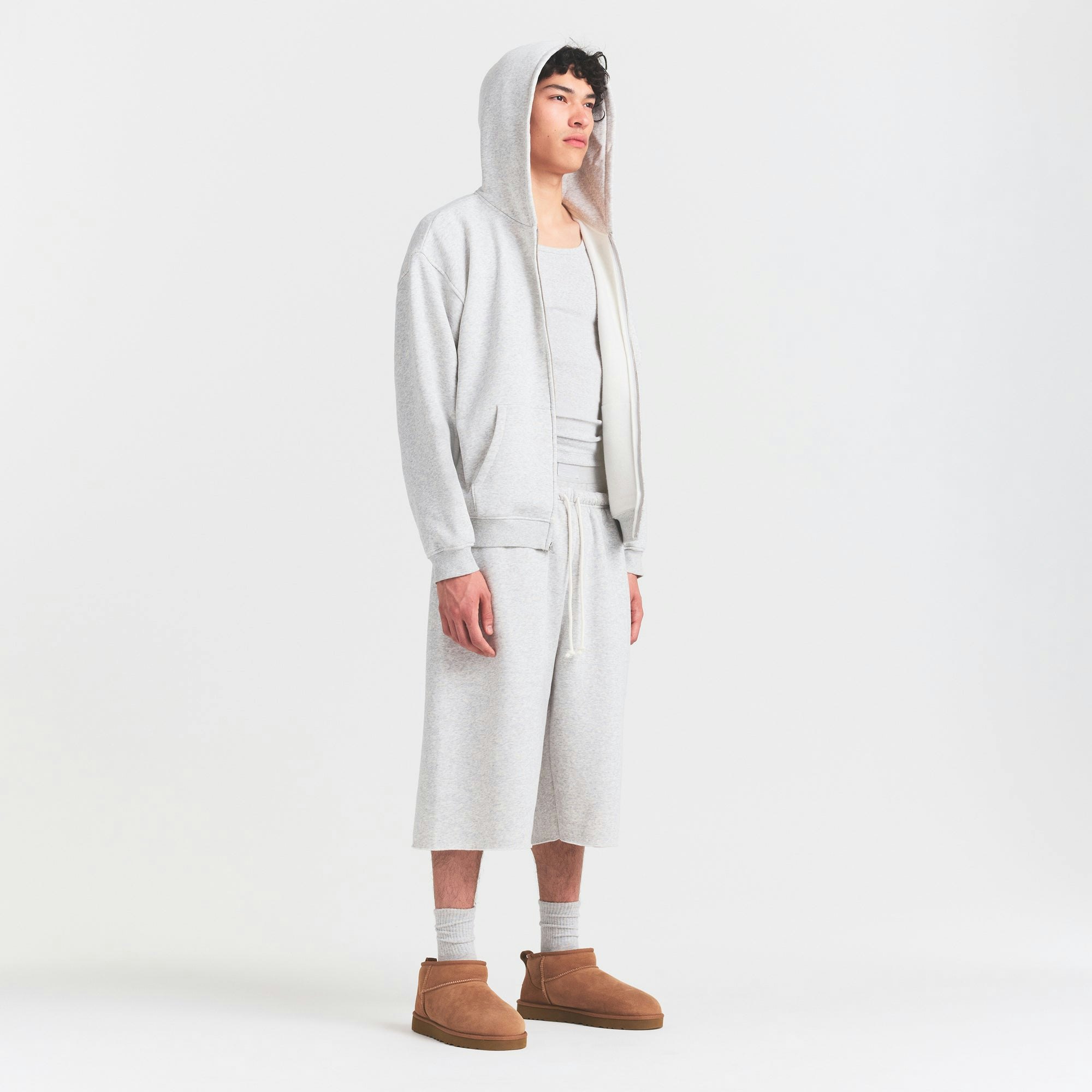 FLEECE LOUNGE MENS RELAXED LONG SHORT | LIGHT HEATHER GREY ON A MODEL FRONT VIEW @ | FOCUS: 0.0, 1.0, 0.9