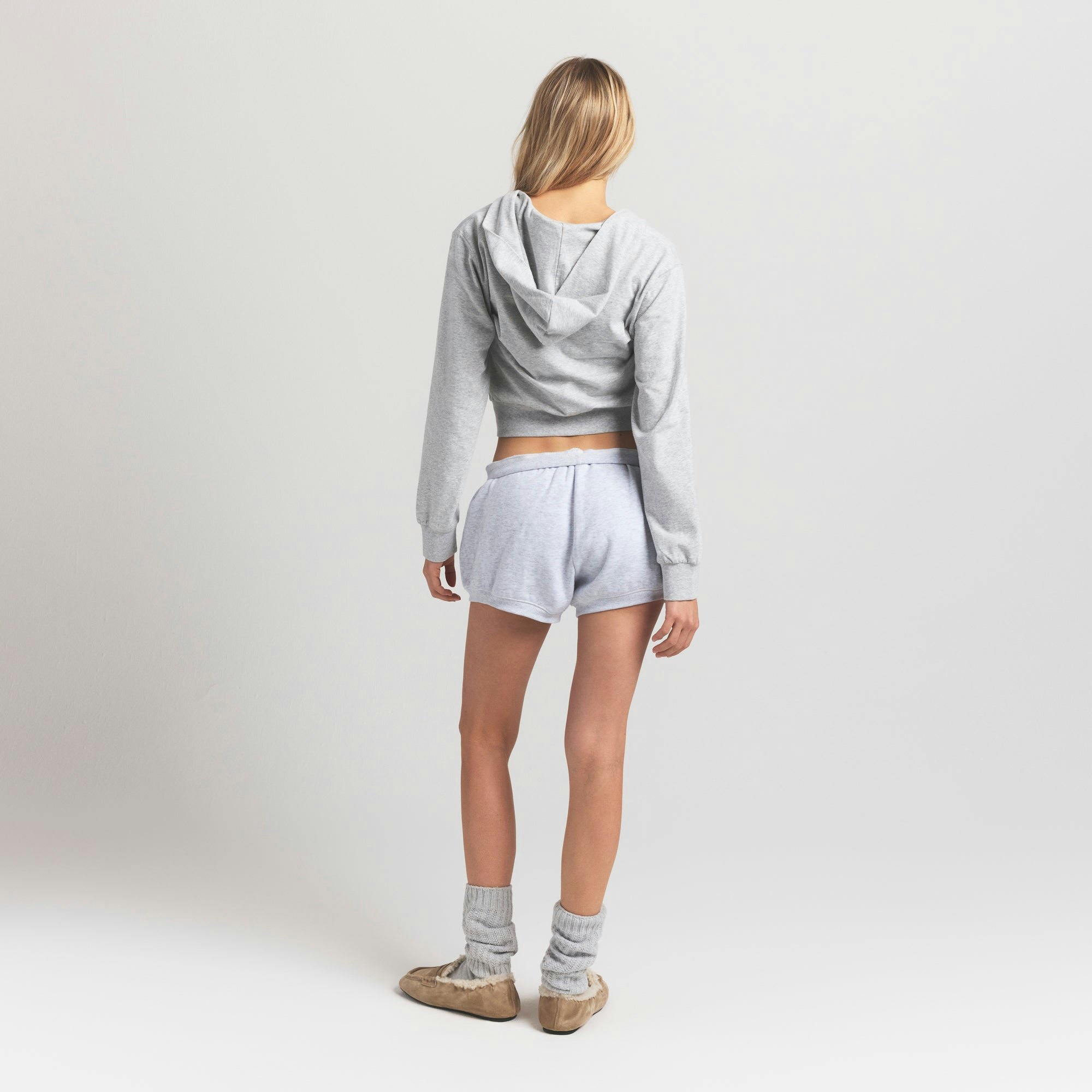 COTTON FLEECE BUBBLE HEM SHORT | LIGHT HEATHER GREY ON A MODEL BACK VIEW @ | FOCUS: 0.9, 0.1, 0.7