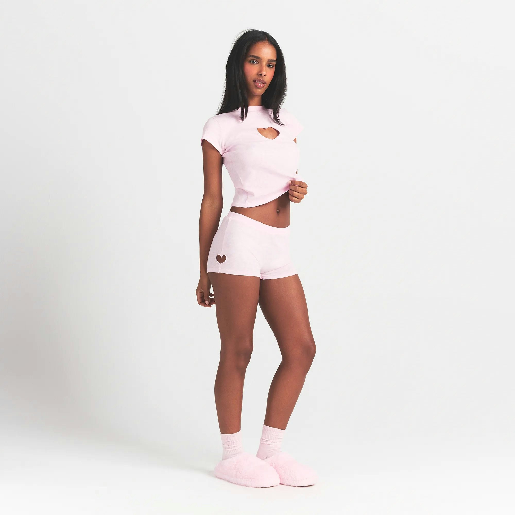 WORN IN JERSEY MICRO HEART SHORT | BABY PINK ON A MODEL SIDE VIEW @ | FOCUS: 0.0, 1.0, 0.9