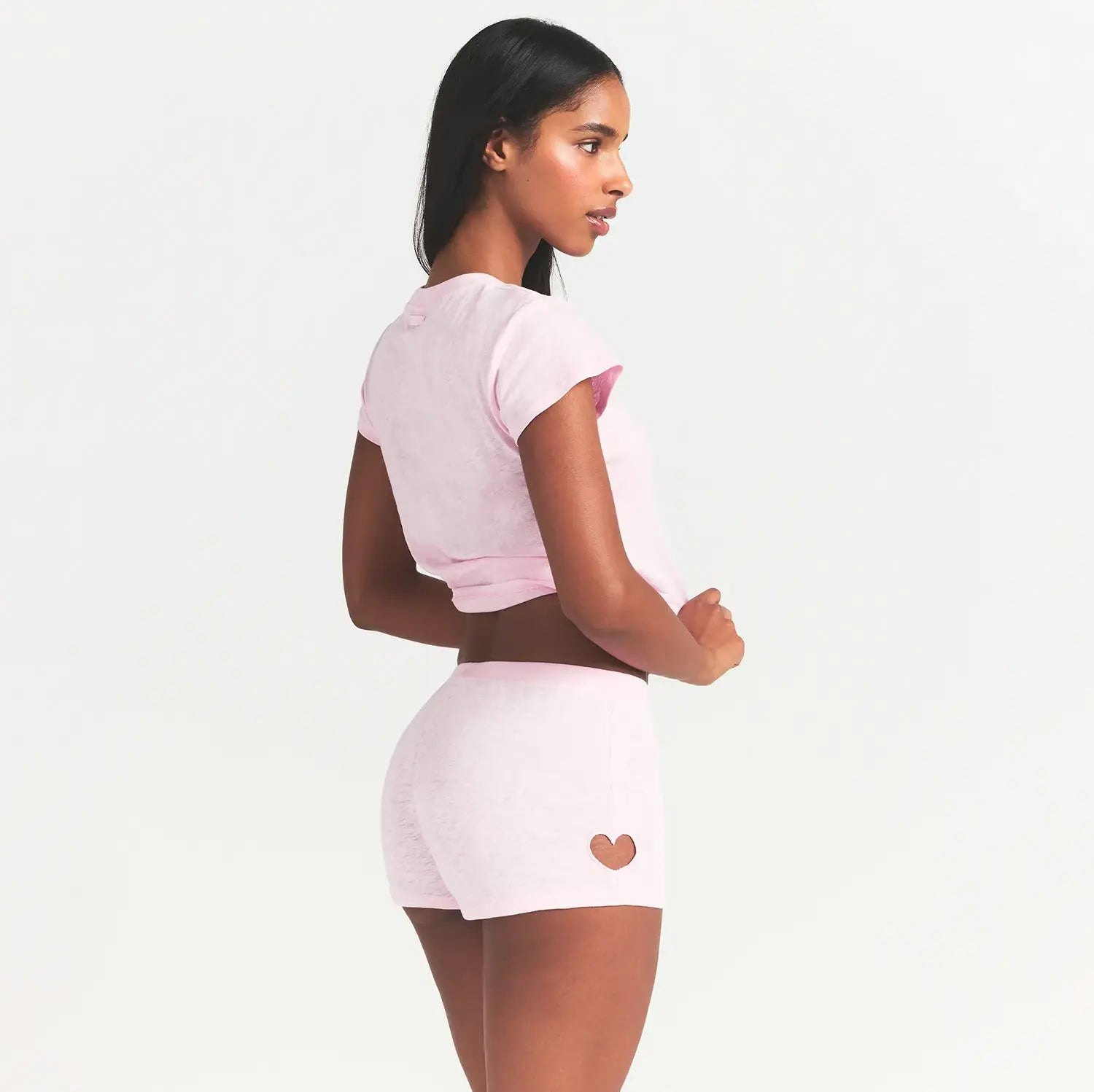 WORN IN JERSEY MICRO HEART SHORT | BABY PINK ON A MODEL SIDE VIEW @ | FOCUS: 0.0, 1.0, 0.9