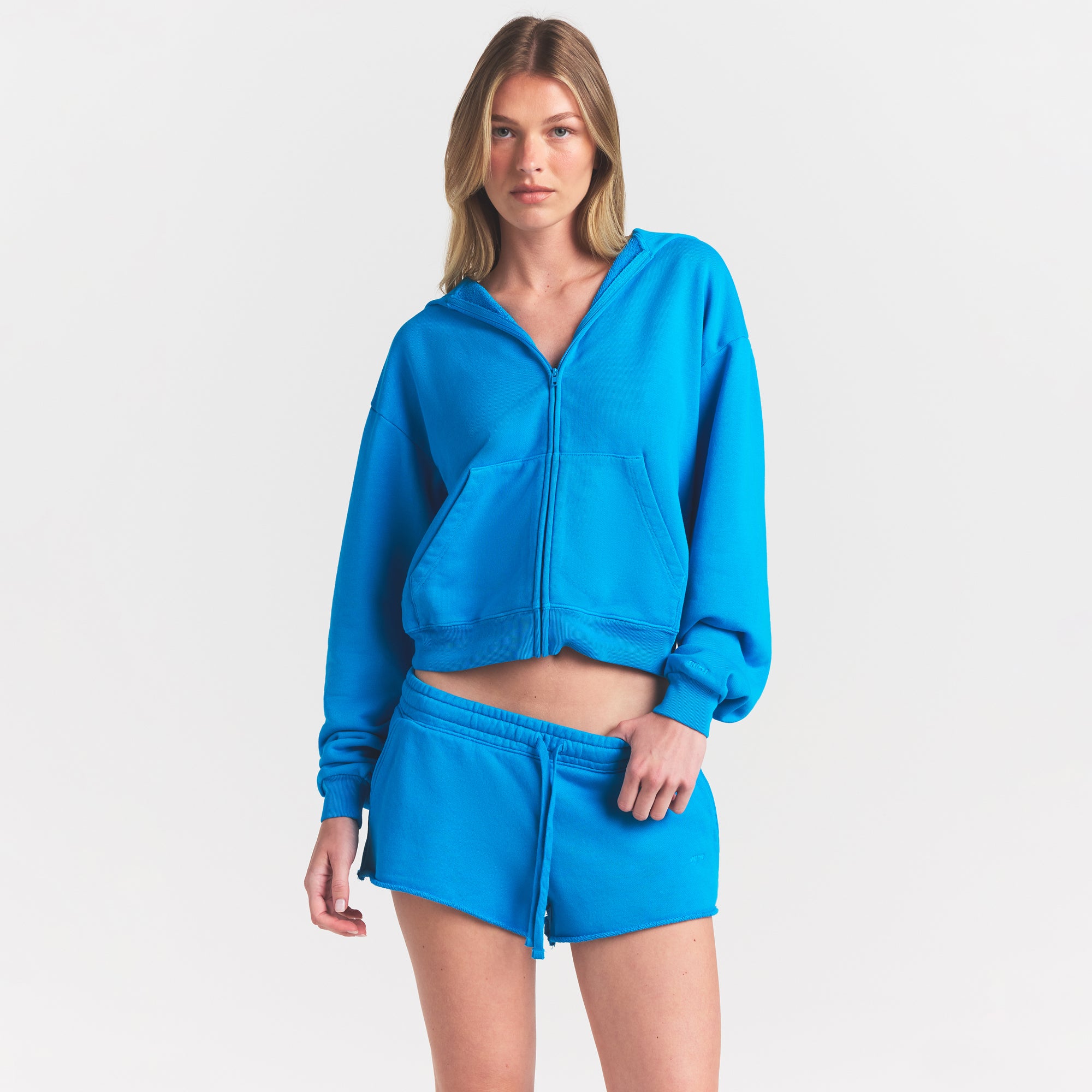 FRENCH TERRY RAW EDGE SHORT | CERULEAN ON A MODEL SIDE VIEW