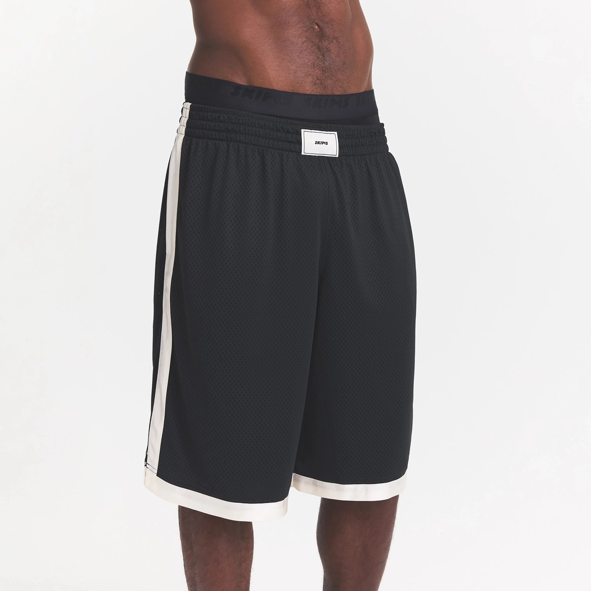 MESH APPAREL MENS LONG SHORT | ONYX ON A MODEL SIDE VIEW @ | FOCUS: 0.0, 1.0, 0.9
