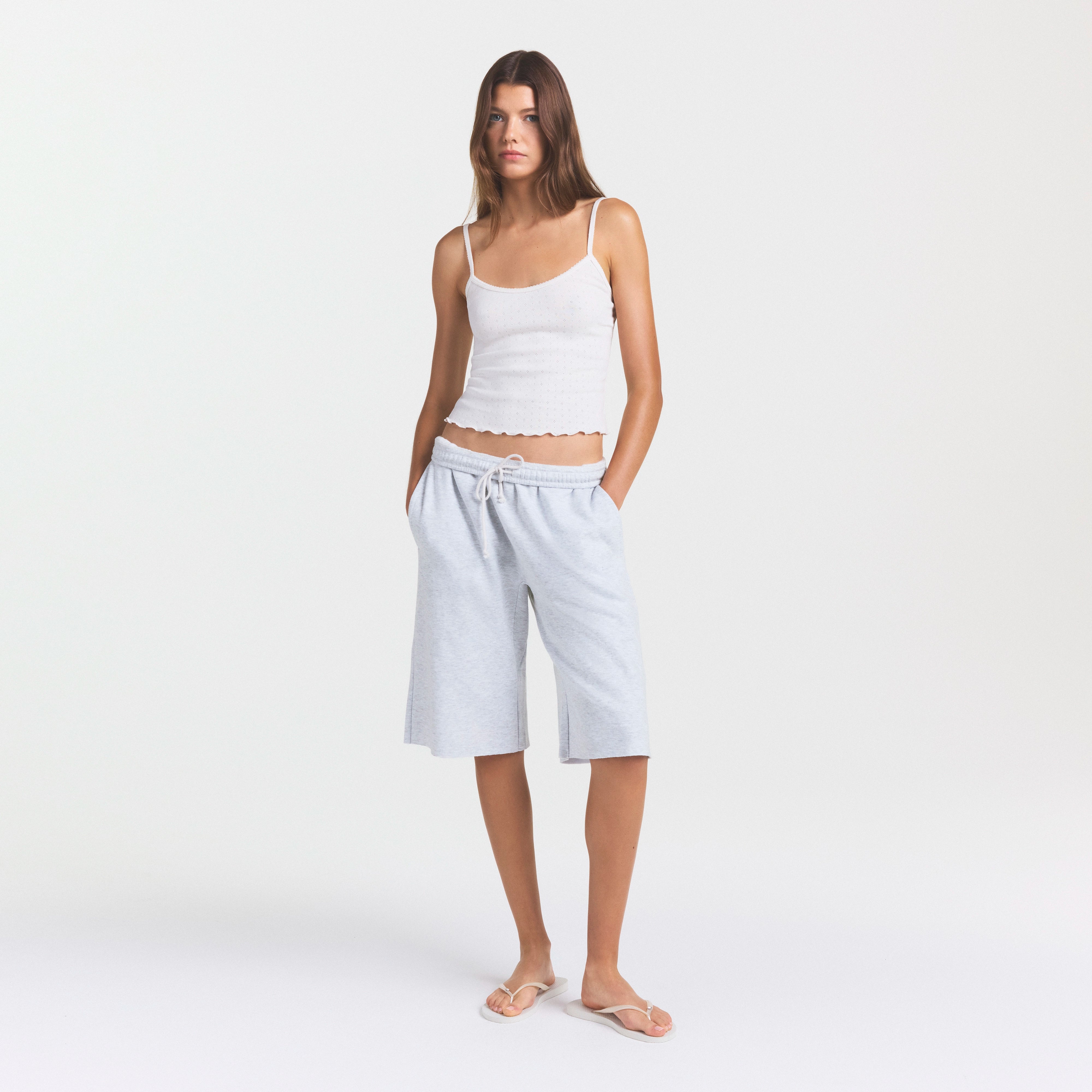 COTTON FLEECE LONG SHORT | LIGHT HEATHER GREY ON A MODEL FRONT VIEW