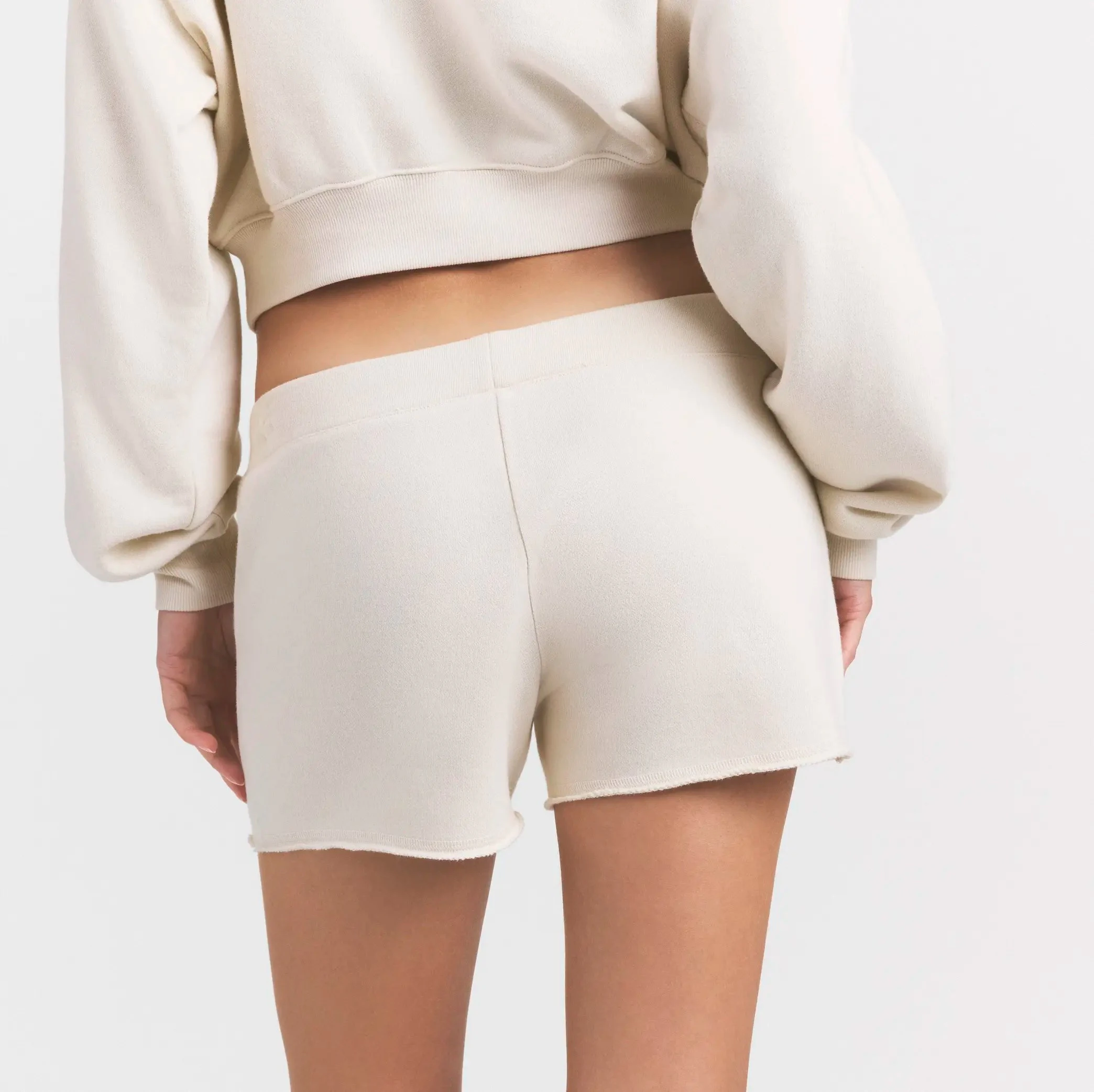 DRAPEY FRENCH TERRY SHORT | BUFF ON A MODEL SIDE VIEW @ | FOCUS: 0.0, 1.0, 0.9