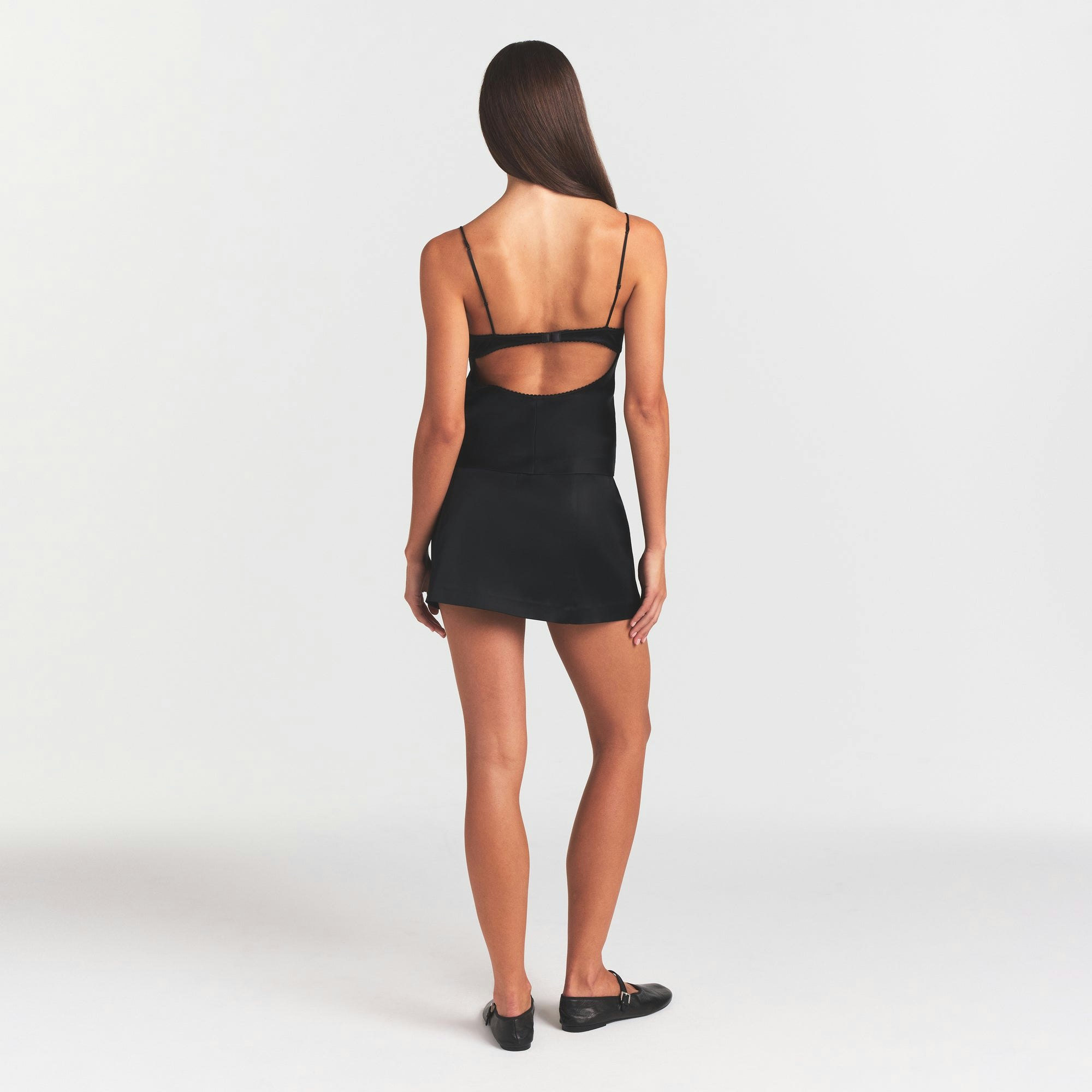 SATIN MINI SKIRT | OBSIDIAN ON A MODEL FRONT VIEW @ | FOCUS: 0.0, 1.0, 0.9