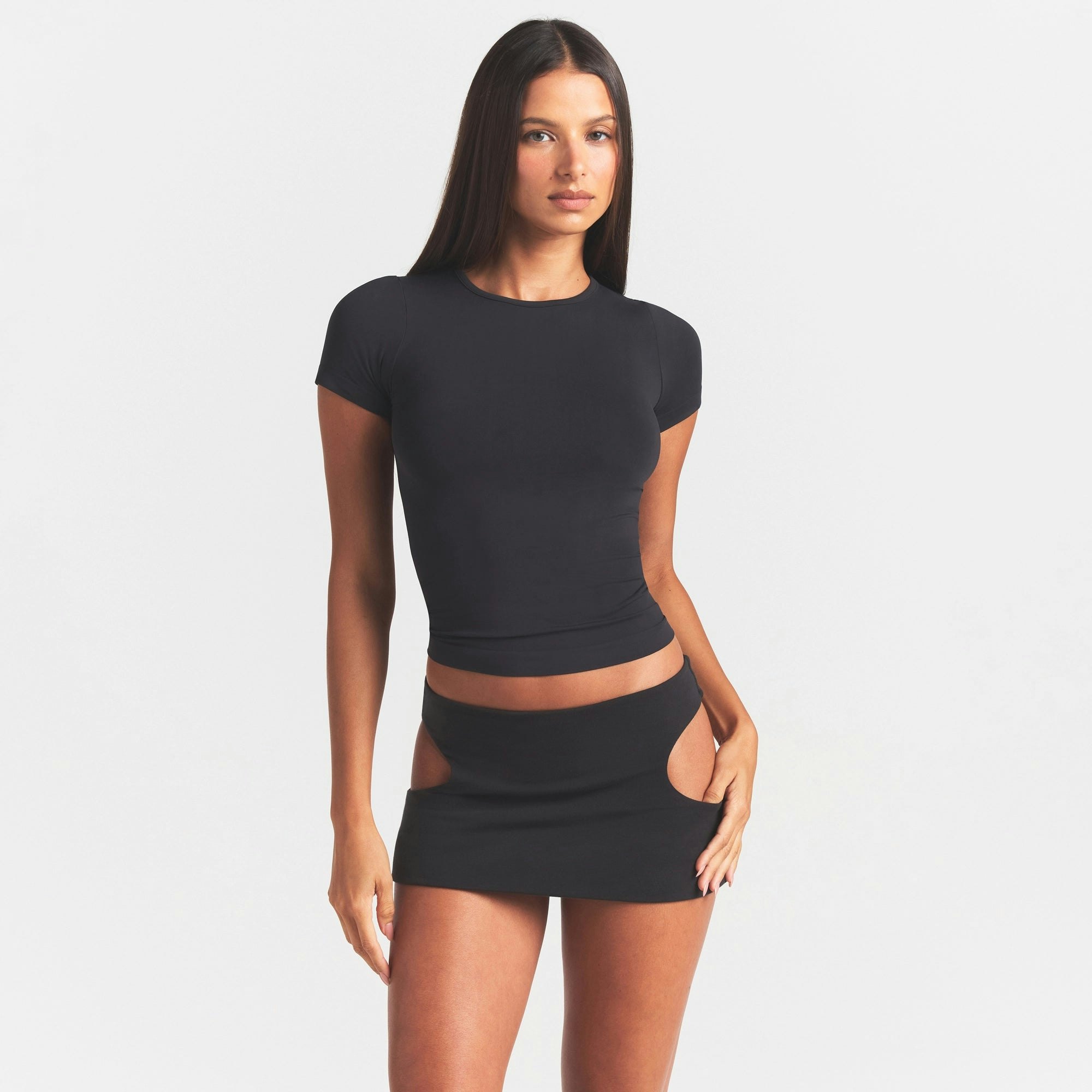 COTTON JERSEY CUT OUT MINI SKIRT | SOOT ON A MODEL SIDE VIEW @ | FOCUS: 0.0, 1.0, 0.9