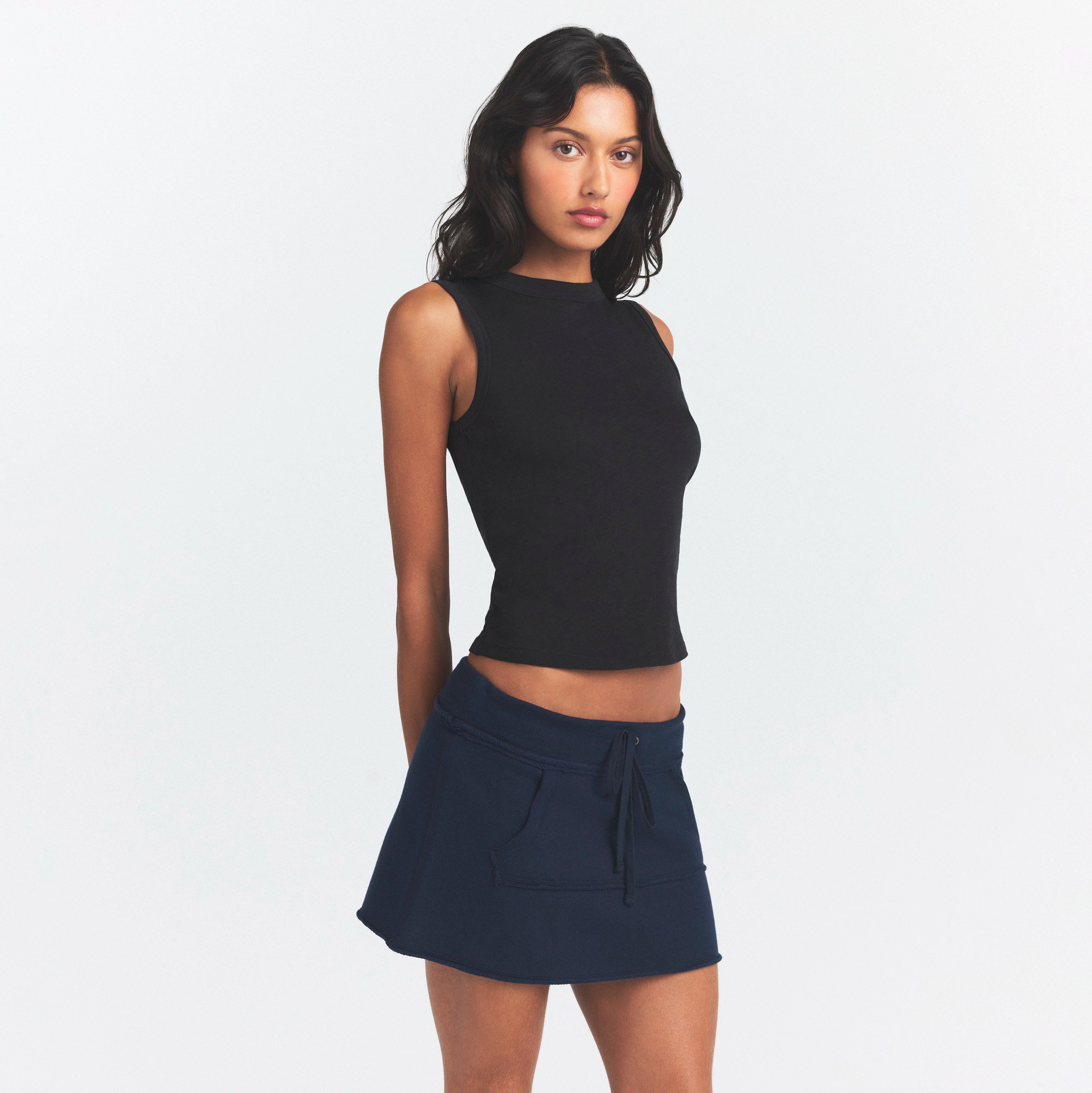 DRAPEY FRENCH TERRY MINI SKIRT | NAVY ON A MODEL SIDE VIEW @ | FOCUS: 0.0, 1.0, 0.9