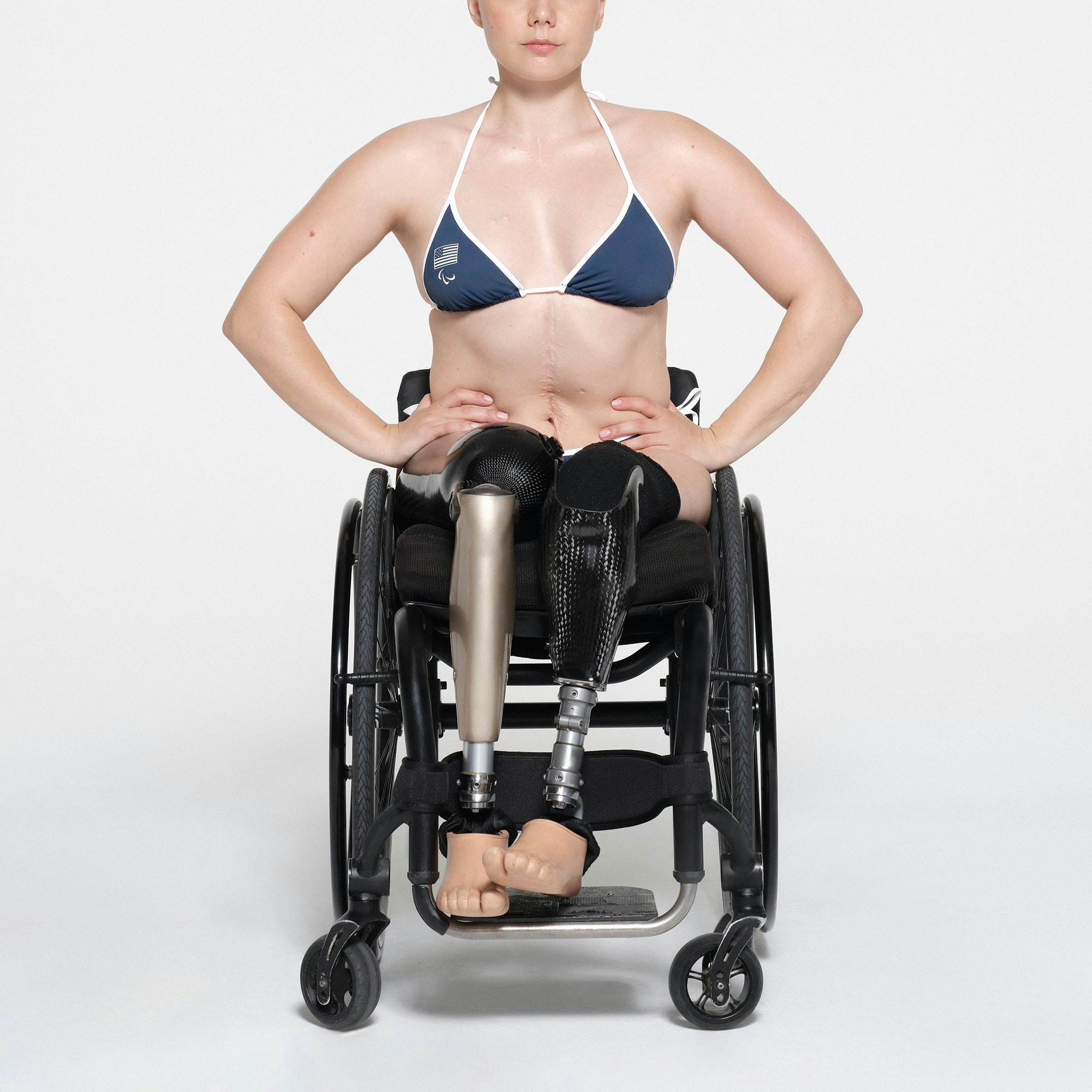 SKIMS FOR TEAM USA SIGNATURE SWIM PARALYMPIC TRIANGLE TOP | NAVY ON A MODEL FRONT VIEW | FOCUS: 0.1, 1, 0.9