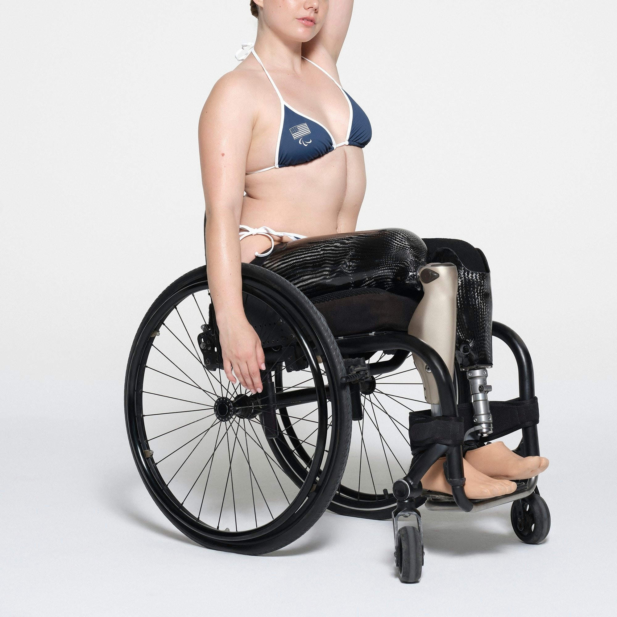 SKIMS FOR TEAM USA SIGNATURE SWIM PARALYMPIC TRIANGLE TOP | NAVY ON A MODEL SIDE VIEW