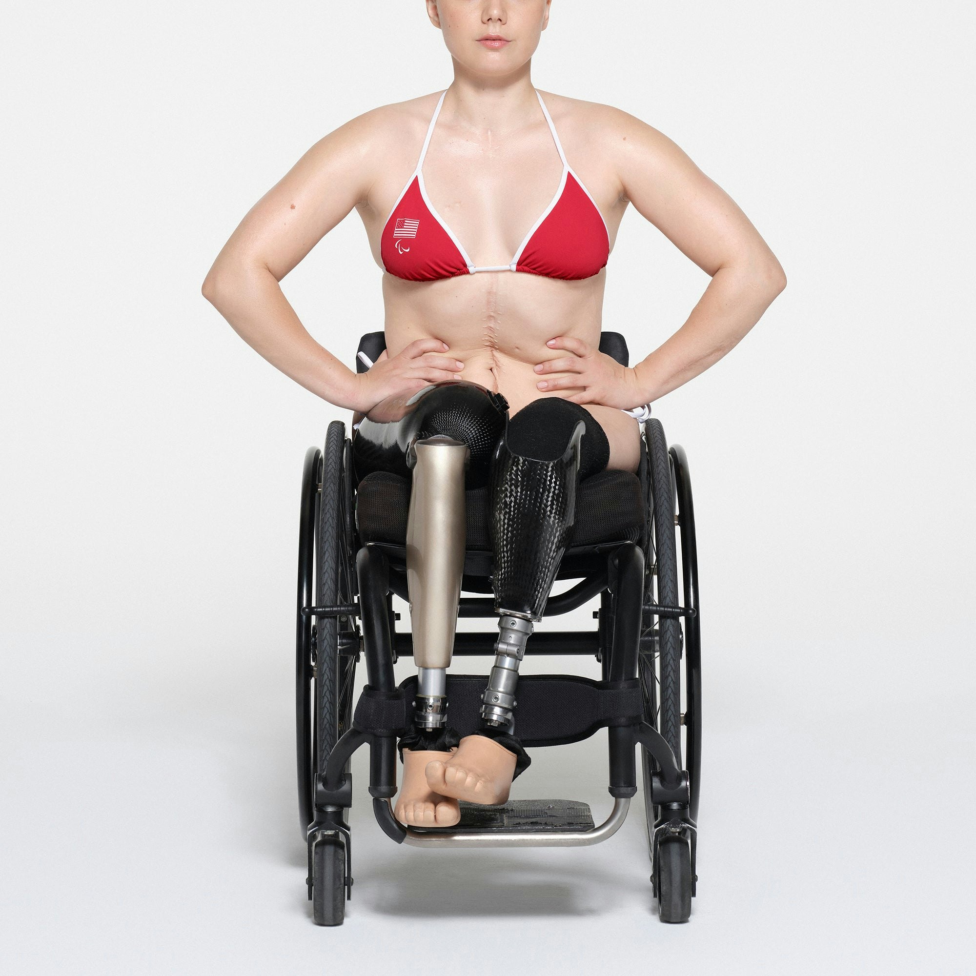SKIMS FOR TEAM USA SIGNATURE SWIM PARALYMPIC TRIANGLE TOP | RED ON A MODEL FRONT VIEW | FOCUS: 0.1, 1, 0.9
