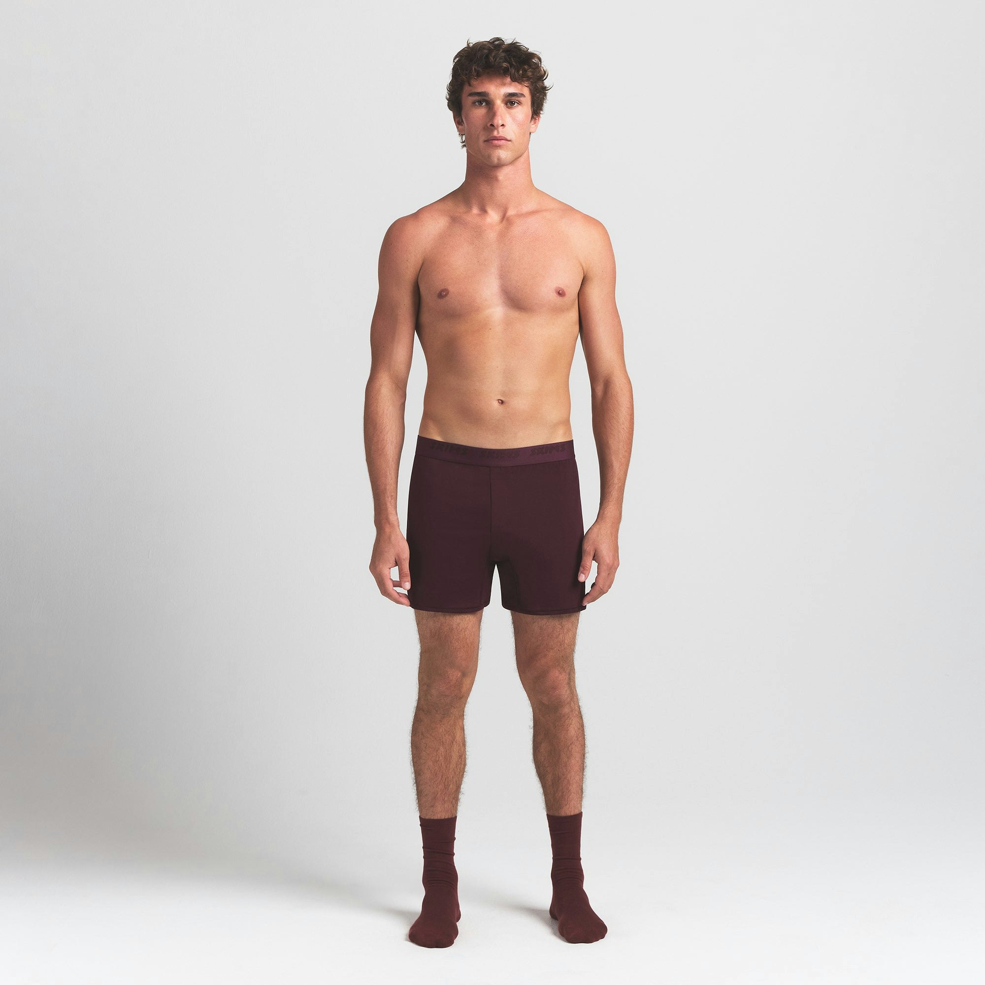 SKIMS STRETCH MENS KNIT BOXER | CURRANT ON A MODEL FRONT VIEW @ | FOCUS: 0.0, 1.0, 0.9