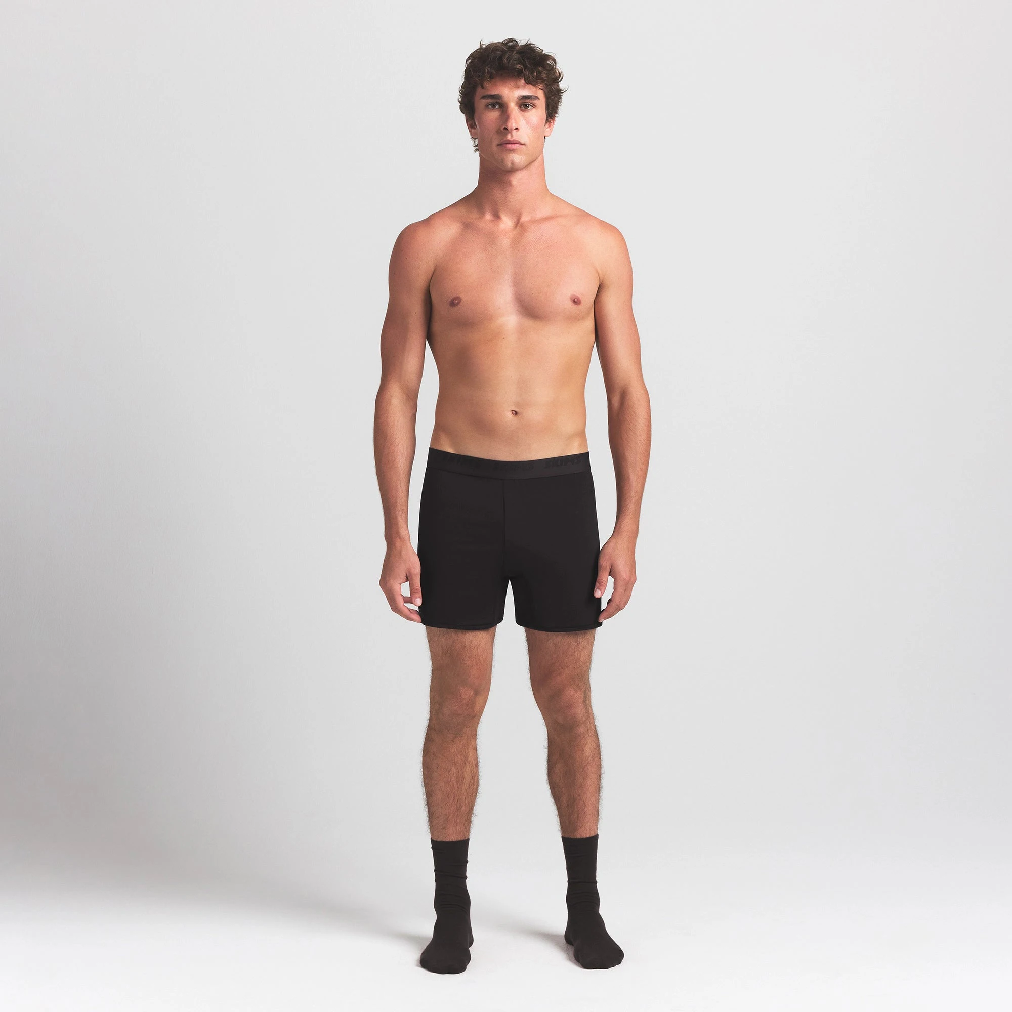 SKIMS STRETCH MENS KNIT BOXER | OBSIDIAN ON A MODEL FRONT VIEW @ | FOCUS: 0.0, 1.0, 0.9