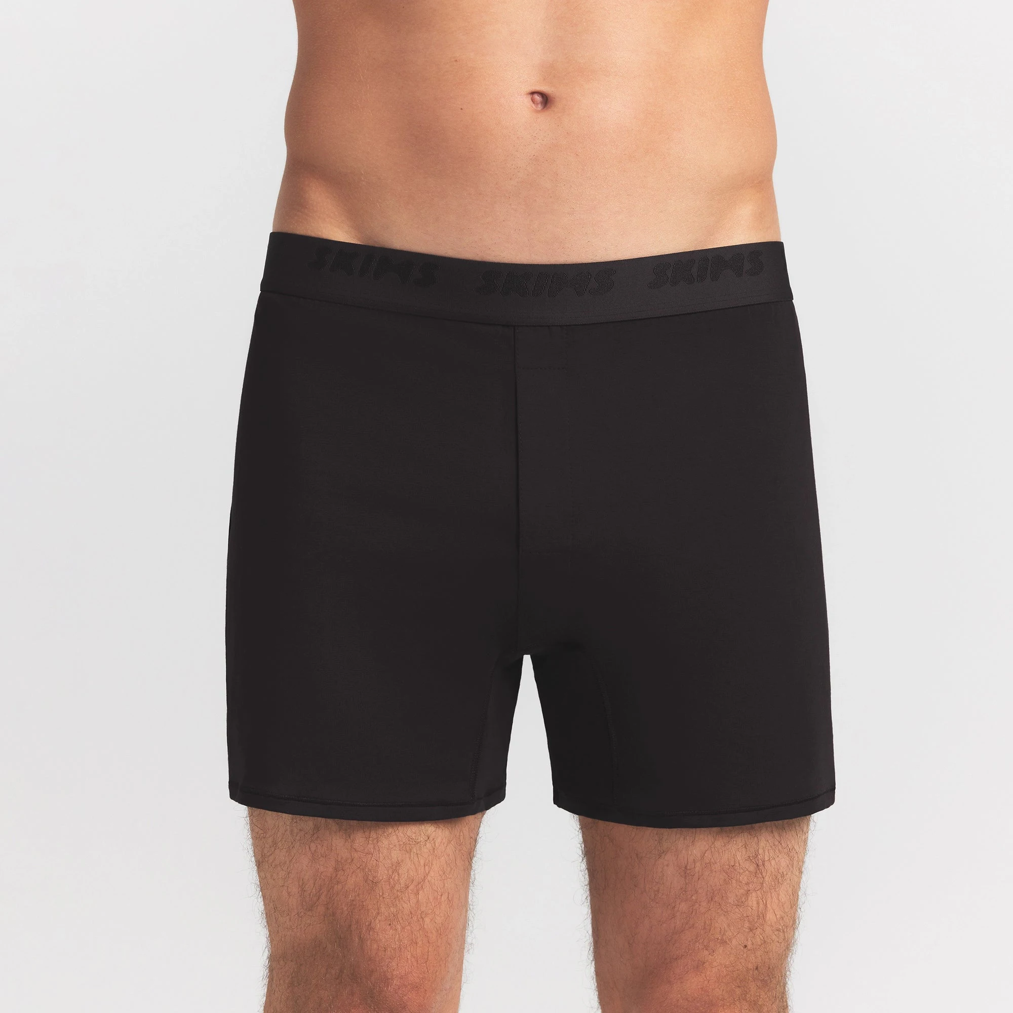 SKIMS STRETCH MENS KNIT BOXER | OBSIDIAN ON A MODEL FRONT VIEW @ | FOCUS: 0.0, 1.0, 0.9
