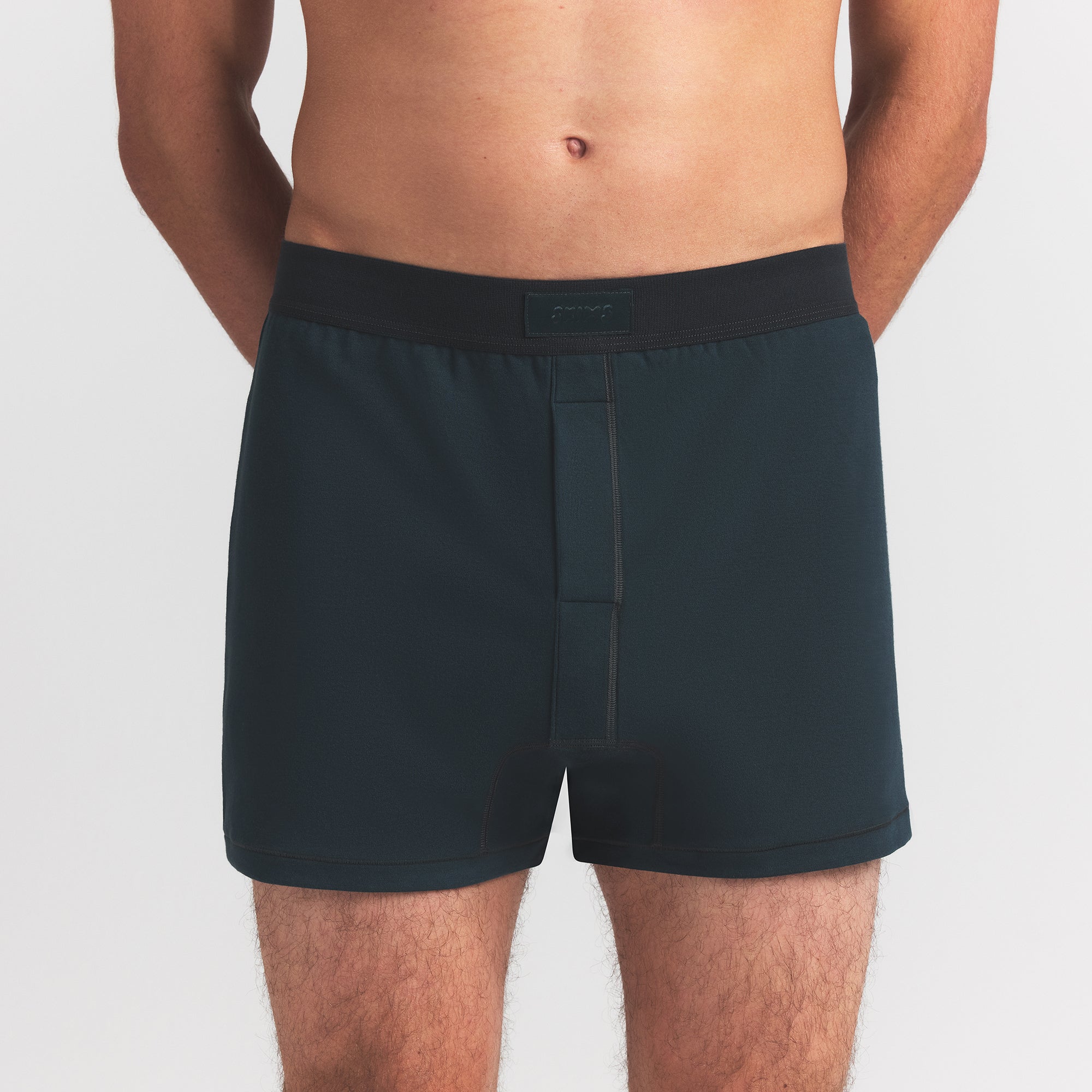 SKIMS COTTON MENS KNIT BOXER | VERDANT ON A MODEL FRONT VIEW @ | FOCUS: 0.0, 1.0, 0.9