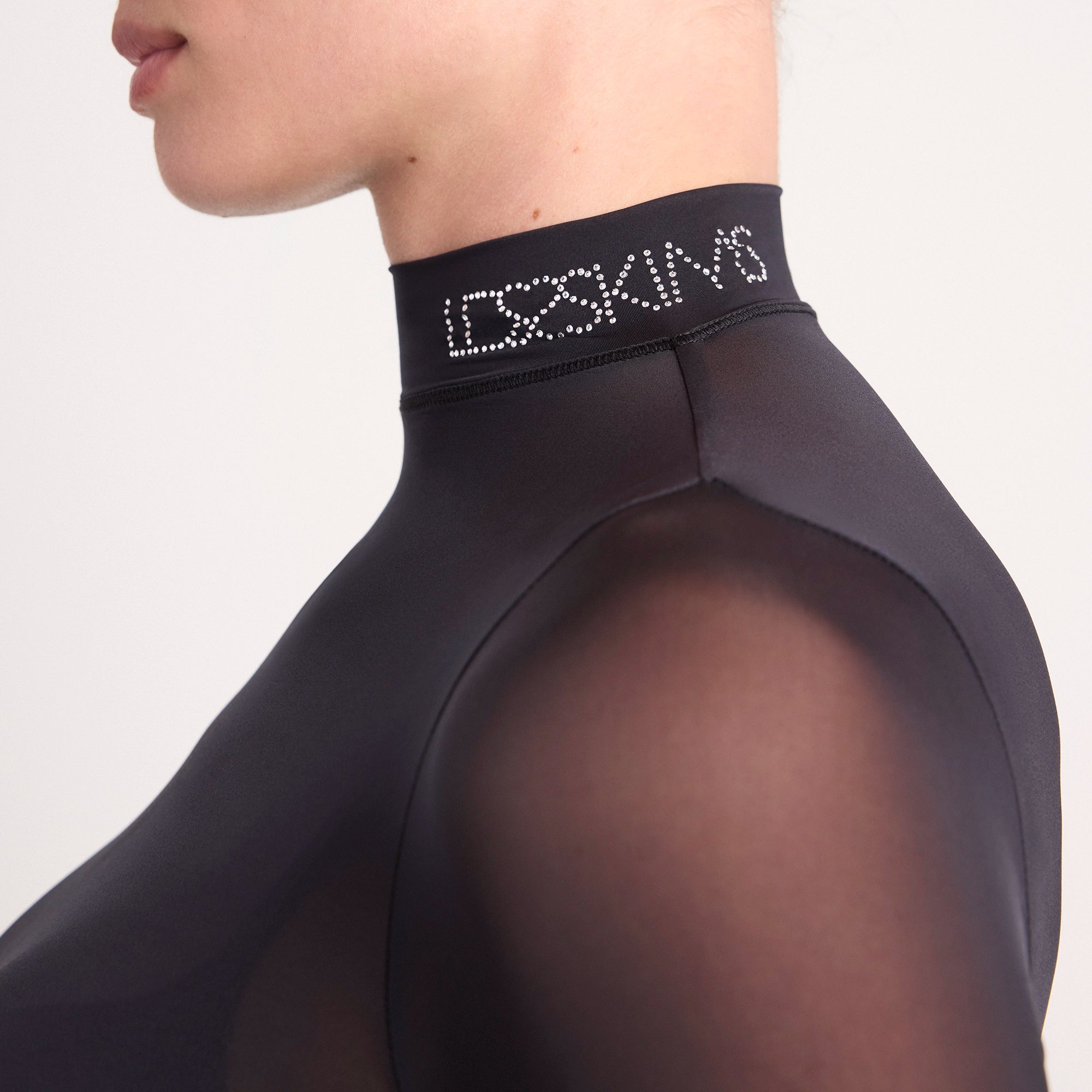 LUDOVIC DE SAINT SERNIN X SKIMS MILKY SHEER MOCK NECK LONG SLEEVE TOP | ONYX ON A MODEL SIDE VIEW @ | FOCUS: 0.0, 1.0, 0.9