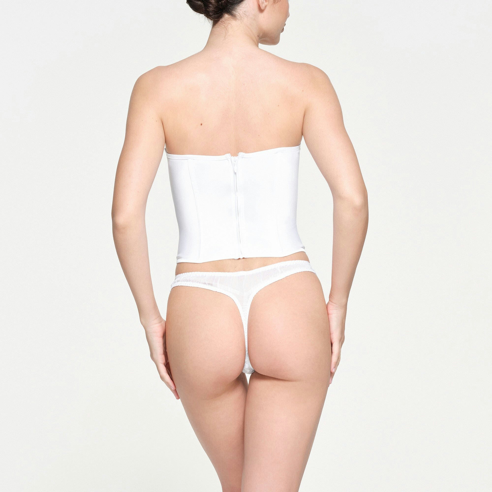 SKIMS ROMANCE SATIN PLUNGE CORSET | SNOW ON A MODEL BACK VIEW