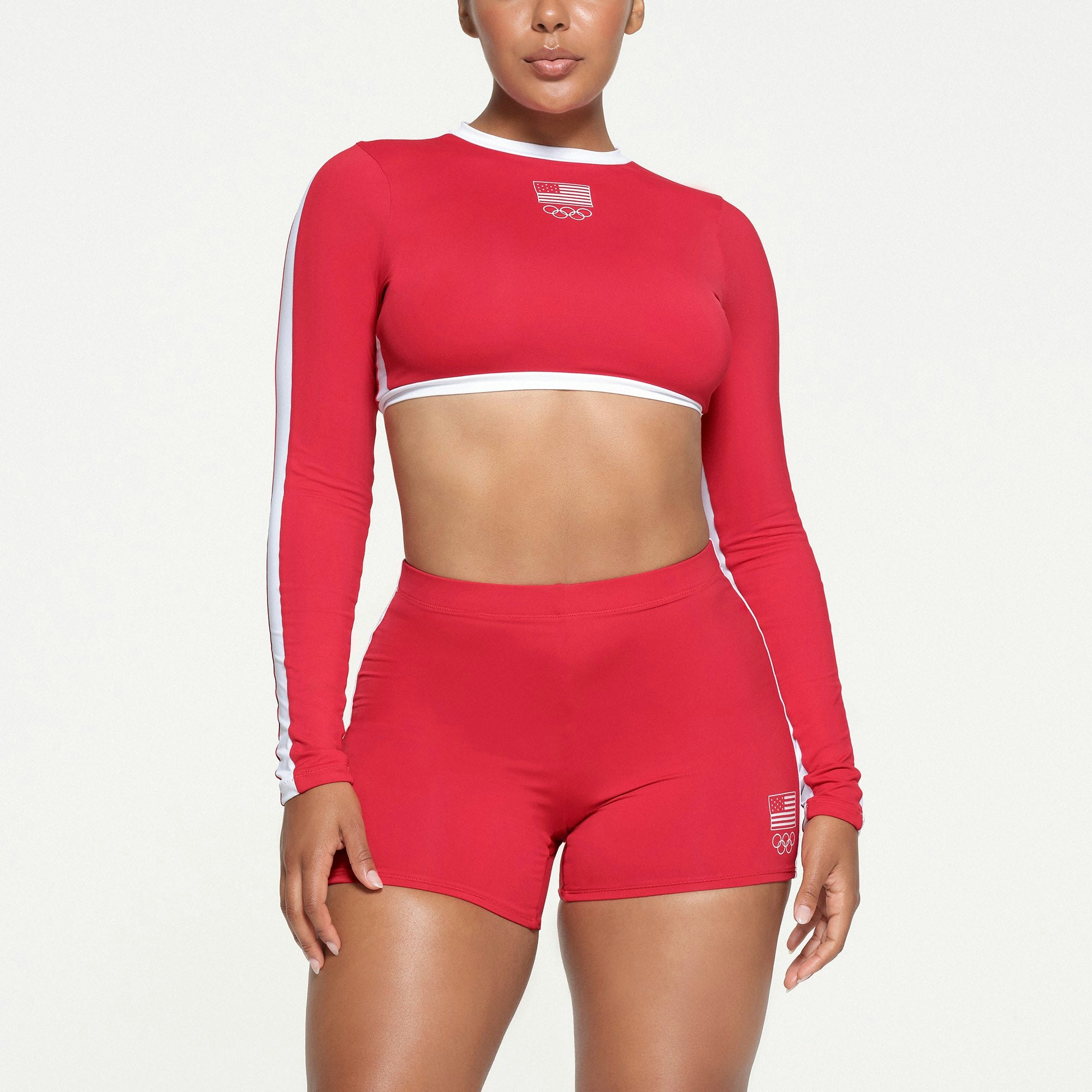 SKIMS FOR TEAM USA SIGNATURE SWIM OLYMPIC LONG SLEEVE CROPPED T-SHIRT | RED ON A MODEL FRONT VIEW
