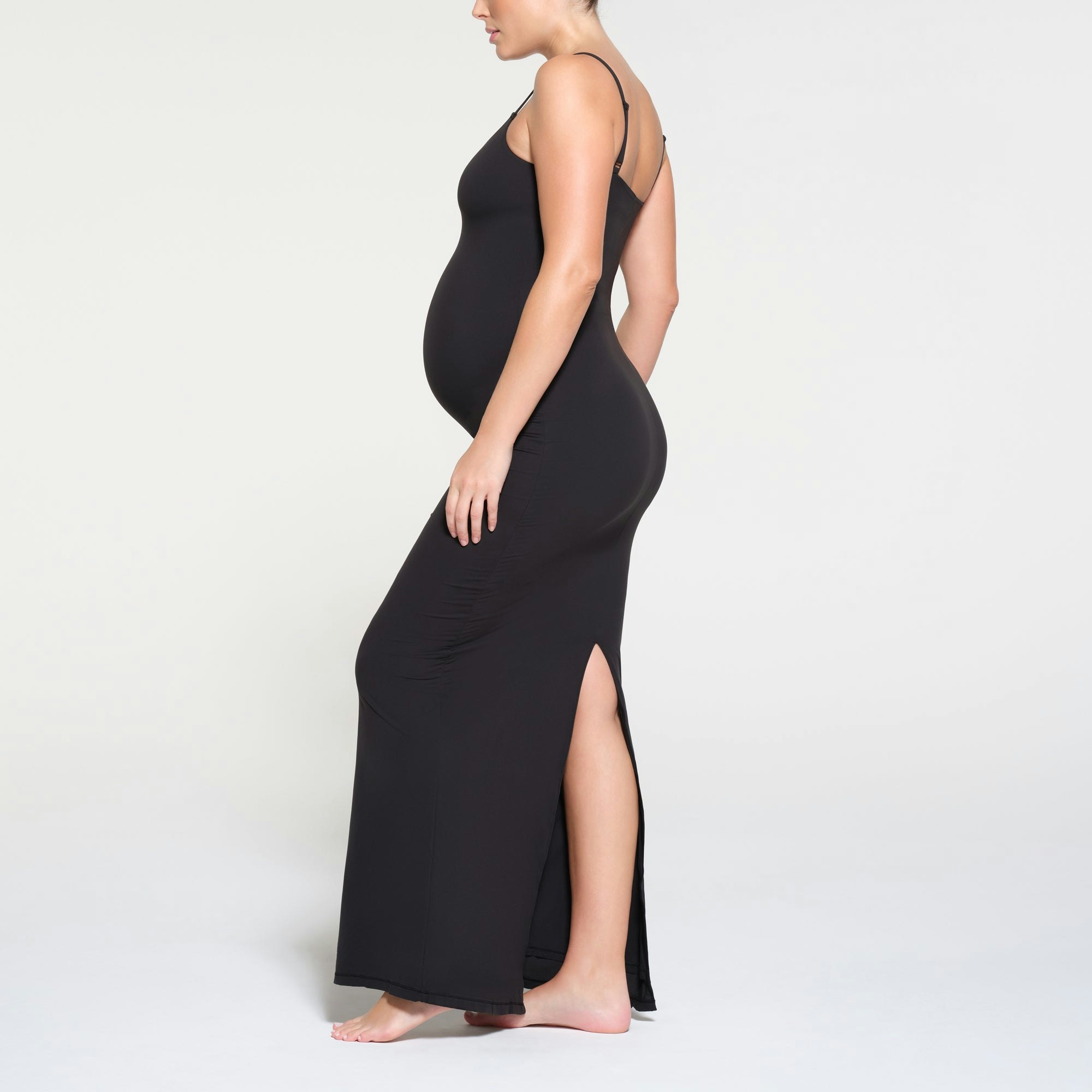 FITS EVERYBODY MATERNITY LONG SLIP DRESS | ONYX ON A MODEL SIDE VIEW