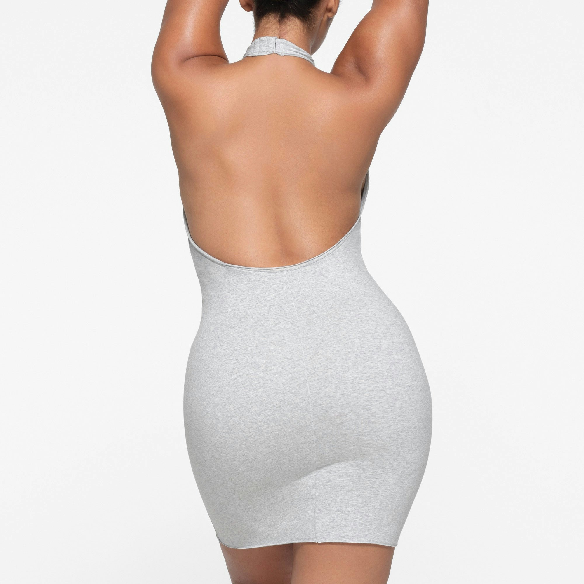 COTTON TWIST HALTER MINI DRESS | LIGHT HEATHER GREY ON A MODEL BACK VIEW