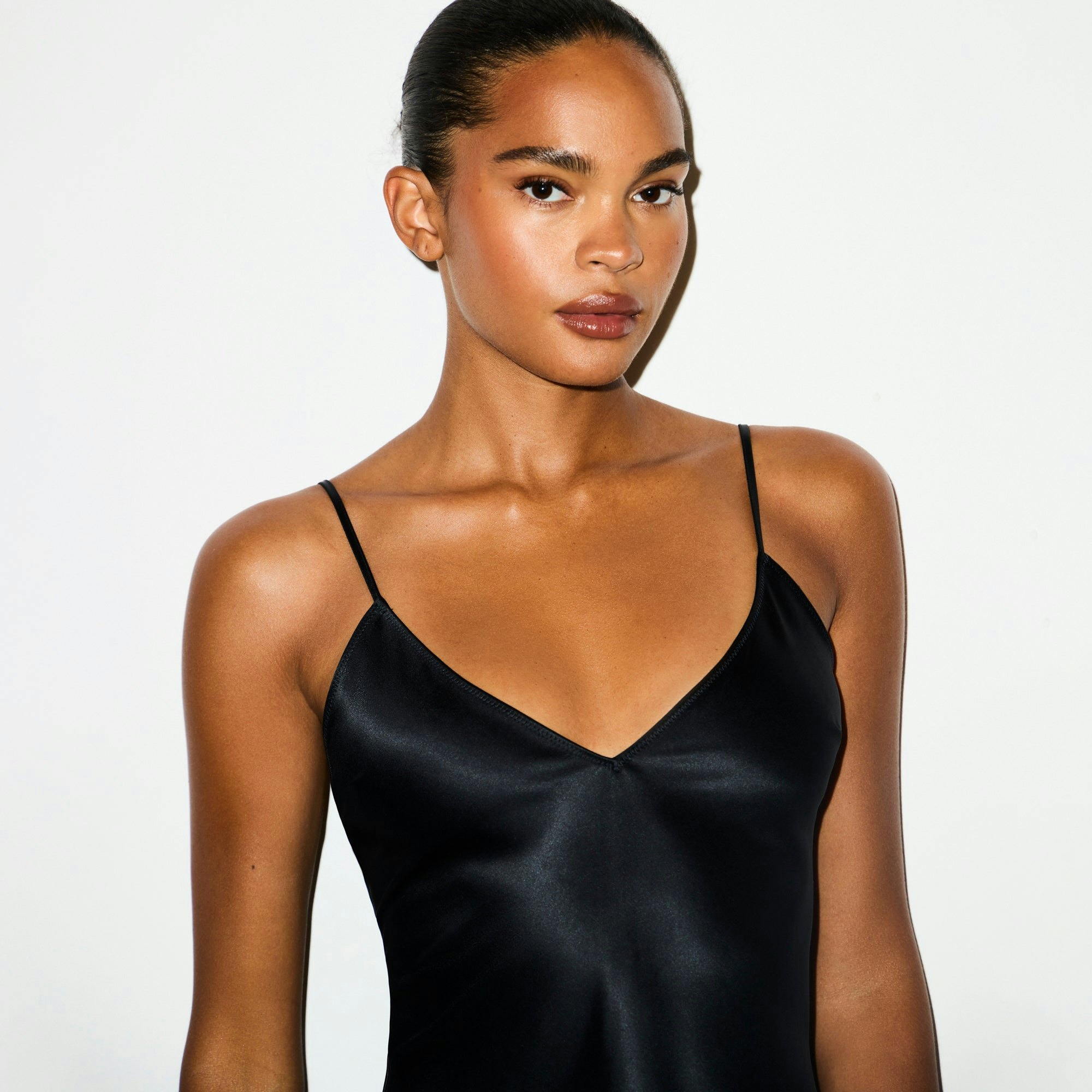 HEAVYWEIGHT SATIN CAMI MINI DRESS | ONYX ON A MODEL SIDE VIEW @ | FOCUS: 0.0, 1.0, 0.9