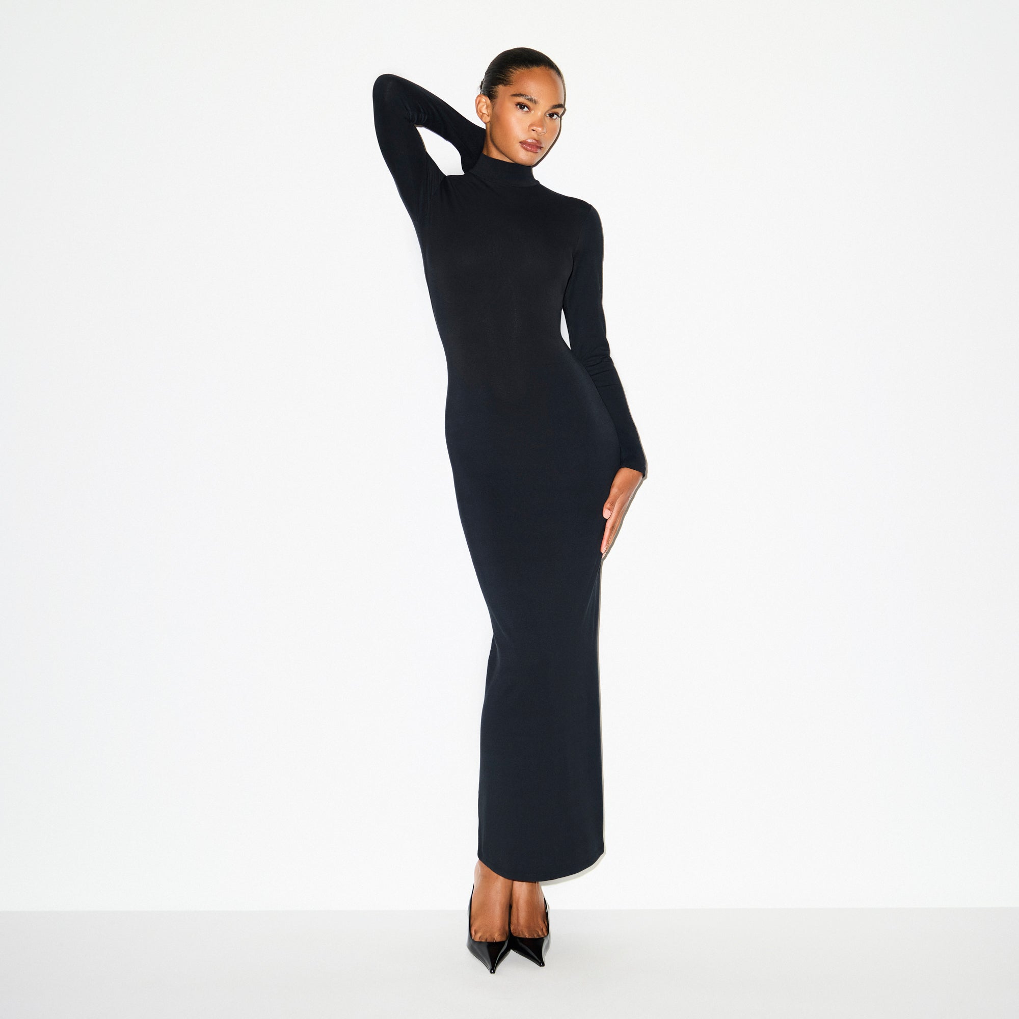 SMOOTH LAYERS TURTLENECK LONG DRESS | OBSIDIAN ON A MODEL SIDE VIEW @ | FOCUS: 0.0, 1.0, 0.9