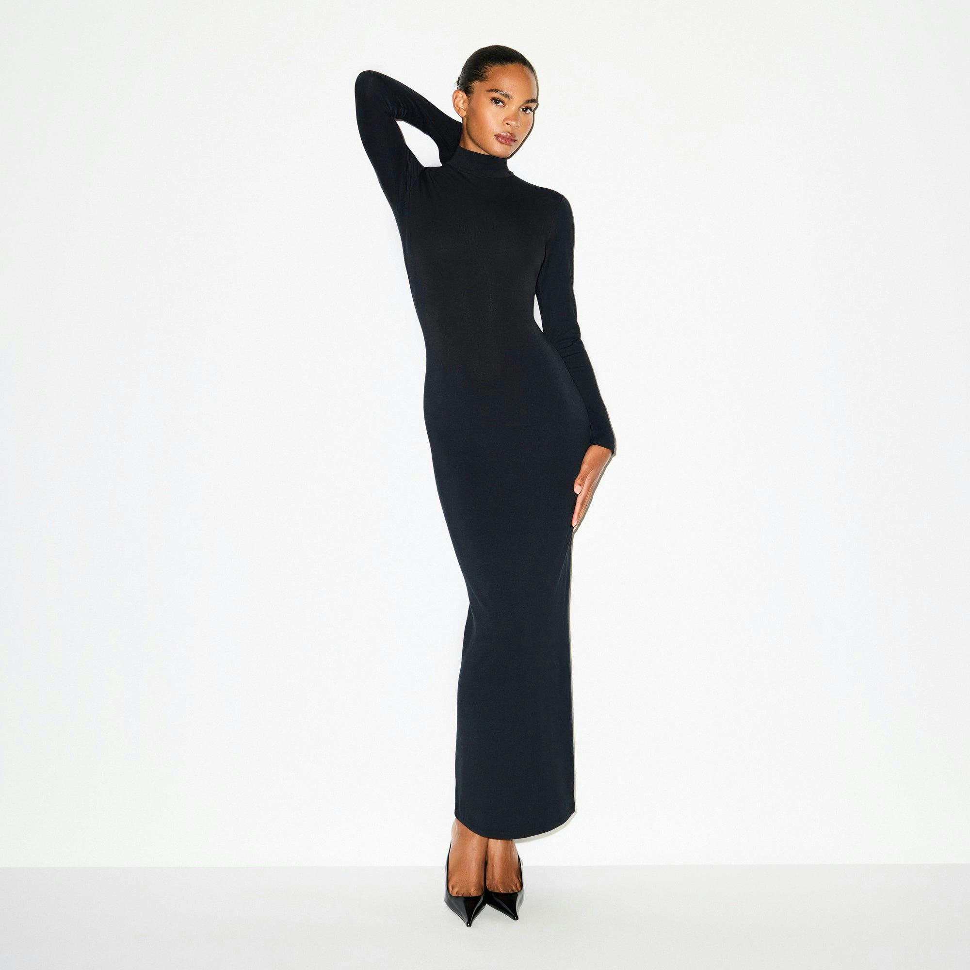 SMOOTH LAYERS TURTLENECK LONG DRESS | OBSIDIAN ON A MODEL SIDE VIEW @ | FOCUS: 0.0, 1.0, 0.9