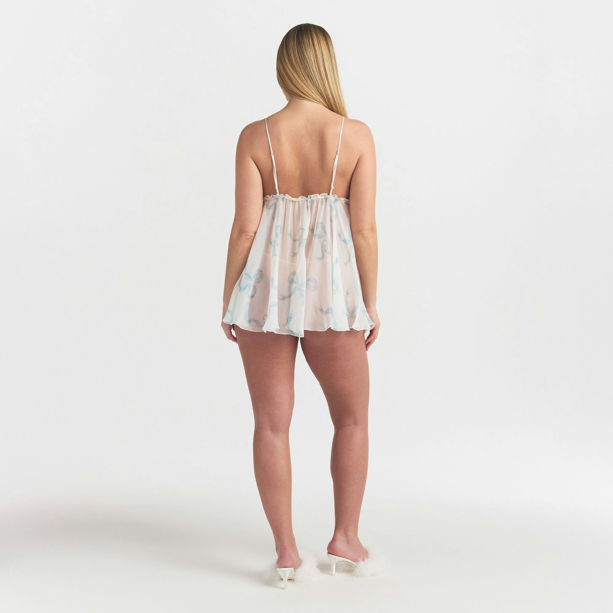 SKIMS ROMANCE BABYDOLL DRESS | IVORY PEARL BOWS PRINT ON A MODEL FRONT VIEW @ | FOCUS: 0.0, 1.0, 0.9