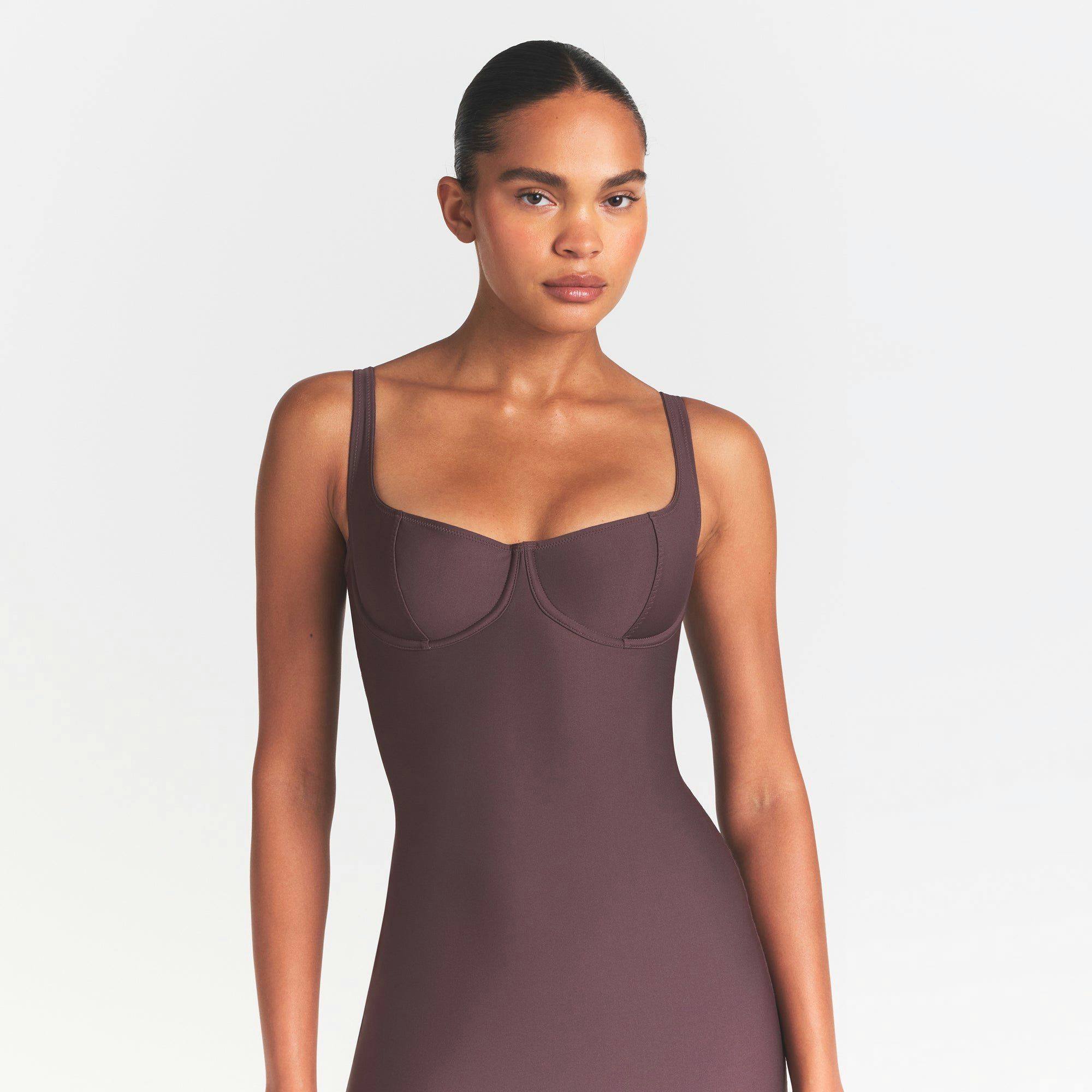 SKIMS BODY MIDI DRESS | RAISIN ON A MODEL SIDE VIEW @ | FOCUS: 0.0, 1.0, 0.9