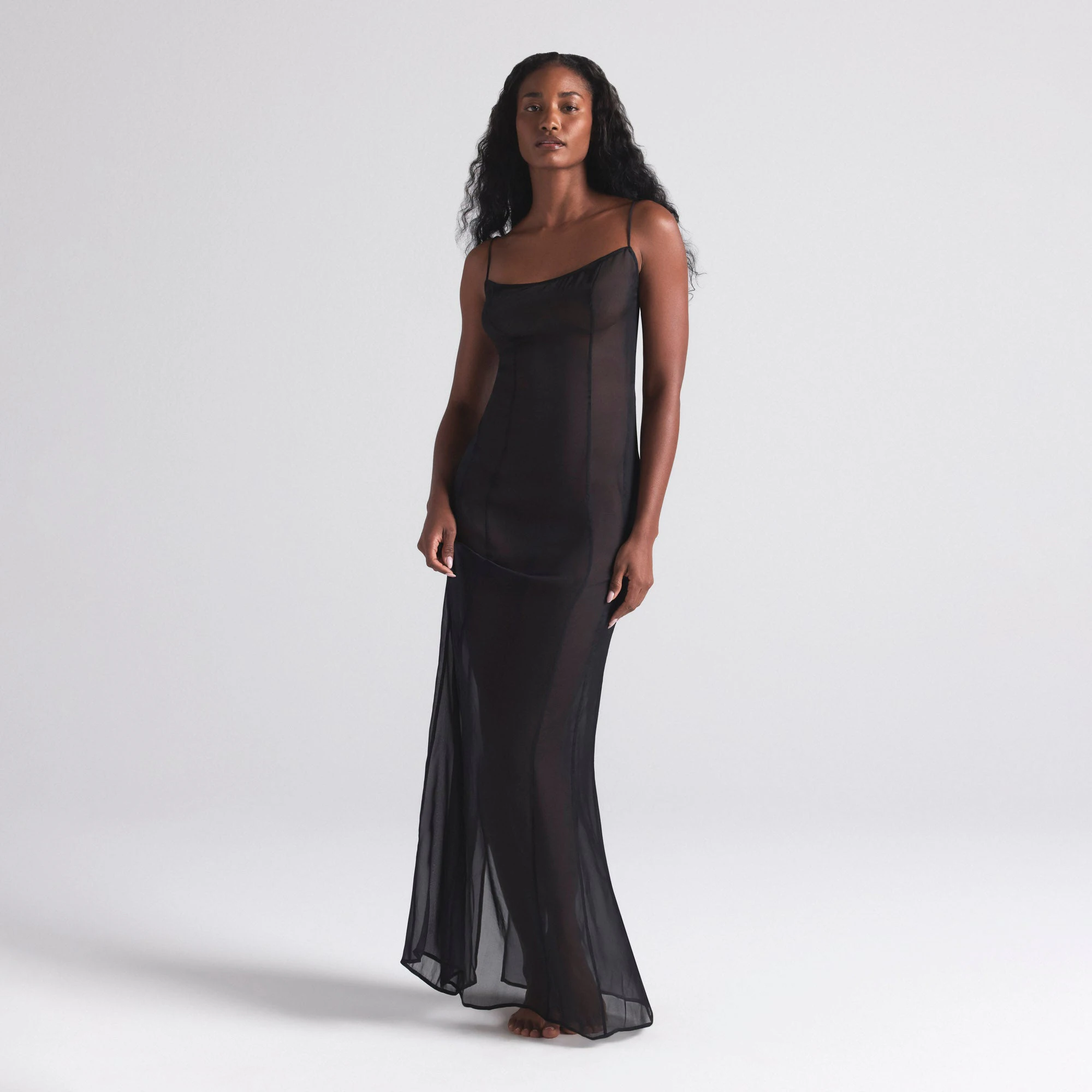 SKIMS ROMANCE LONG SLIP DRESS | ONYX ON A MODEL FRONT  ON A MODEL FRONT VIEW | FOCUS: 0.0, 1.0, 0.9
