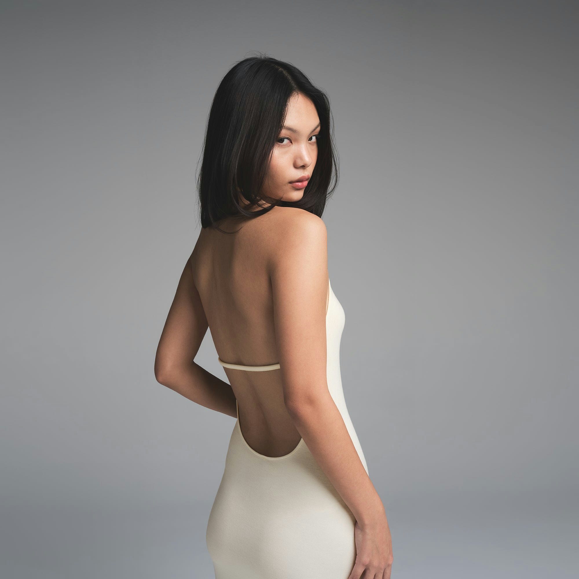 SKIMS CLOUD HALTER LONG DRESS | ECRU ON A MODEL SIDE VIEW | FOCUS: 0.0, 1.0, 0.9