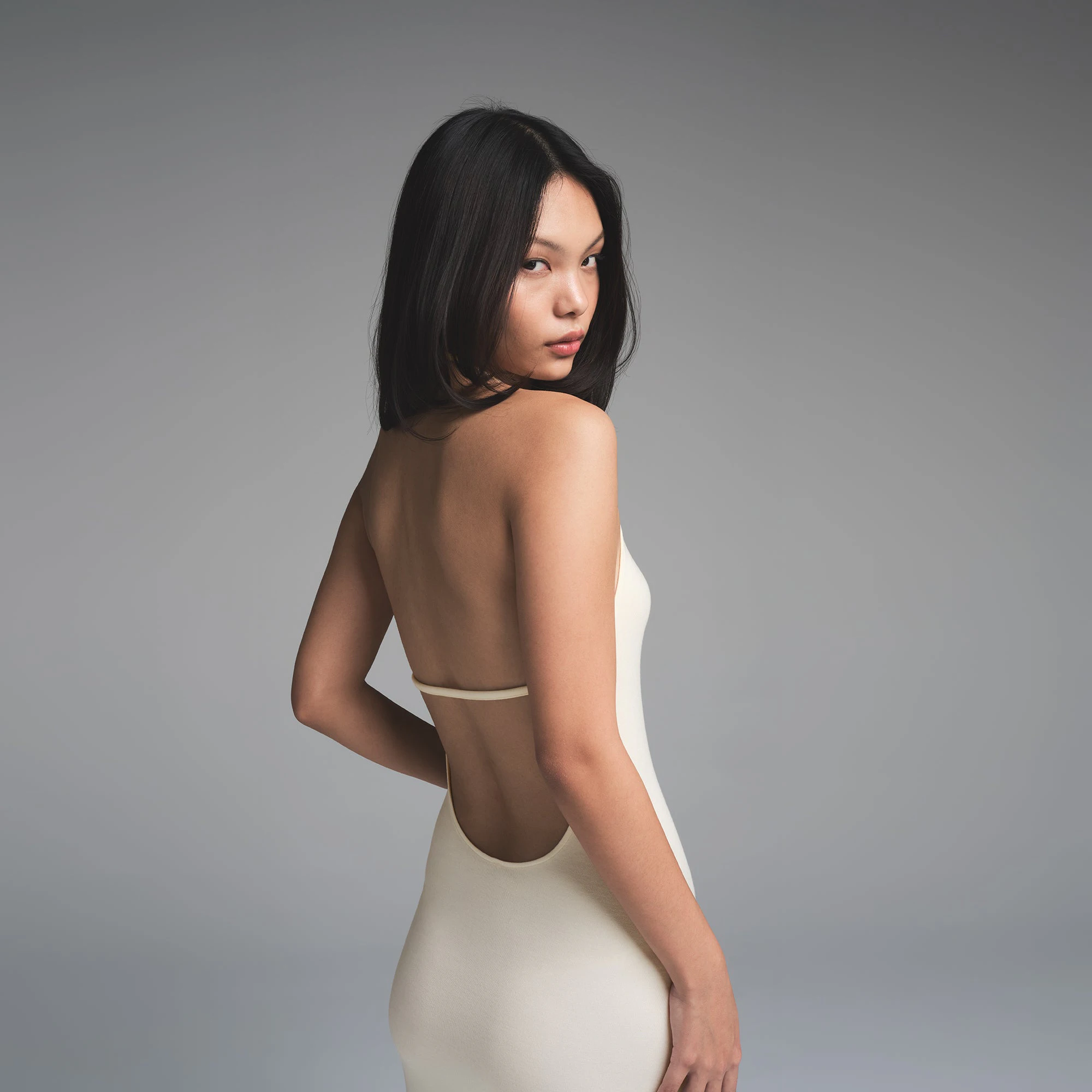 SKIMS CLOUD HALTER LONG DRESS | ECRU ON A MODEL SIDE VIEW | FOCUS: 0.0, 1.0, 0.9