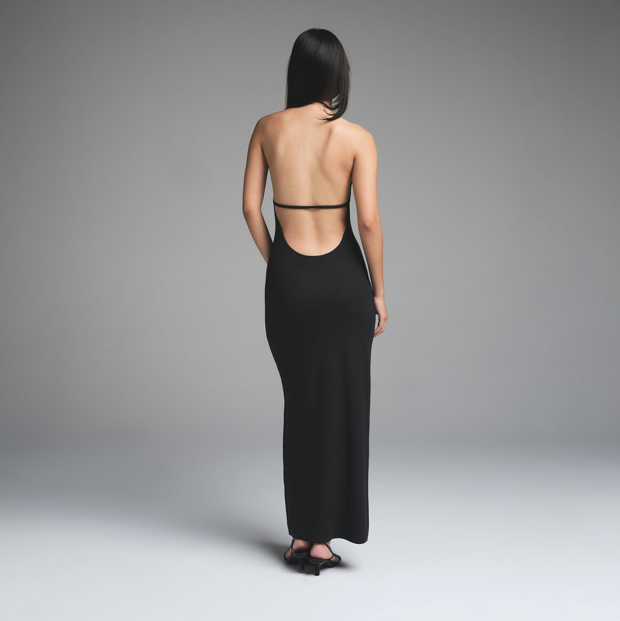 SKIMS CLOUD HALTER LONG DRESS | ONYX ON A MODEL BACK VIEW | FOCUS: 0.0, 1.0, 0.9