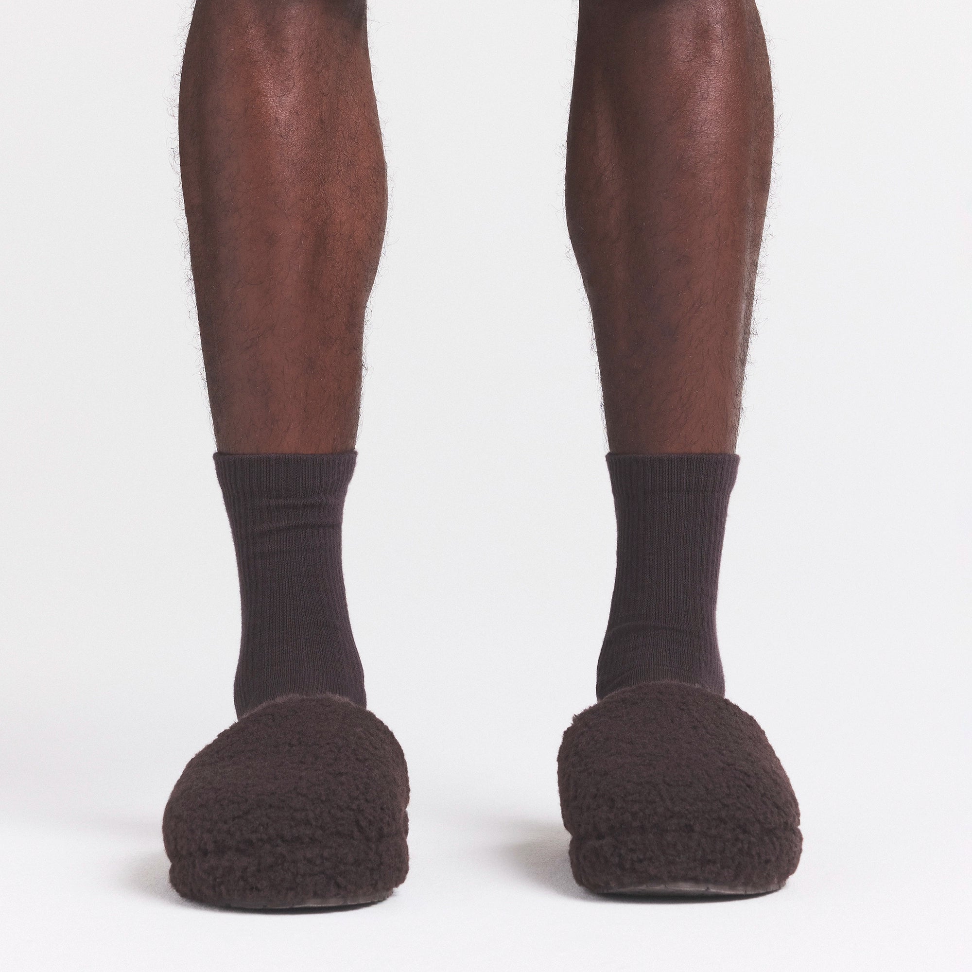 SHERPA MENS SLIPPER | DARK ROAST ON A MODEL FRONT VIEW @ | FOCUS: 0.0, 1.0, 0.9