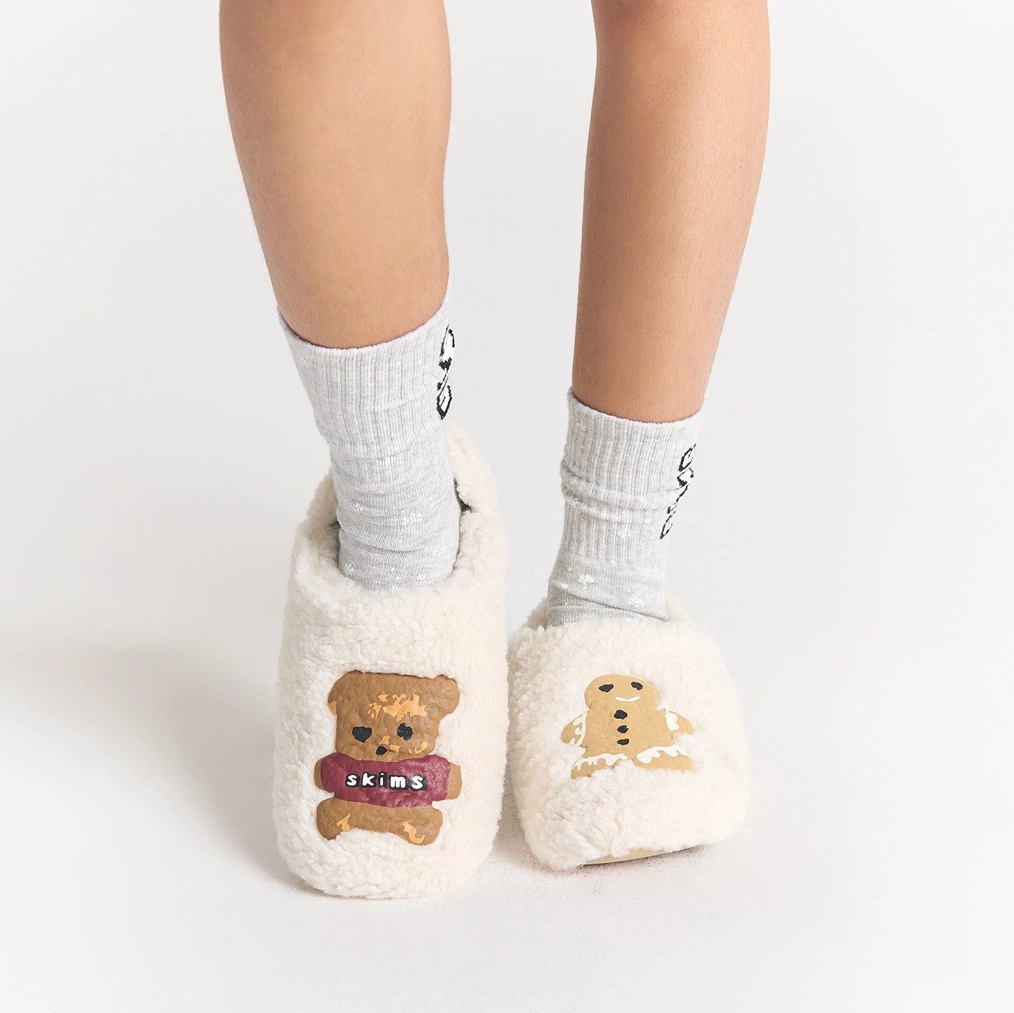CACTUS PLANT FLEA MARKET X SKIMS SHERPA SLIPPER | MARBLE TEDDY BEAR PRINT ON A MODEL SIDE VIEW FOCUS: 0.0, 1.0, 0.9