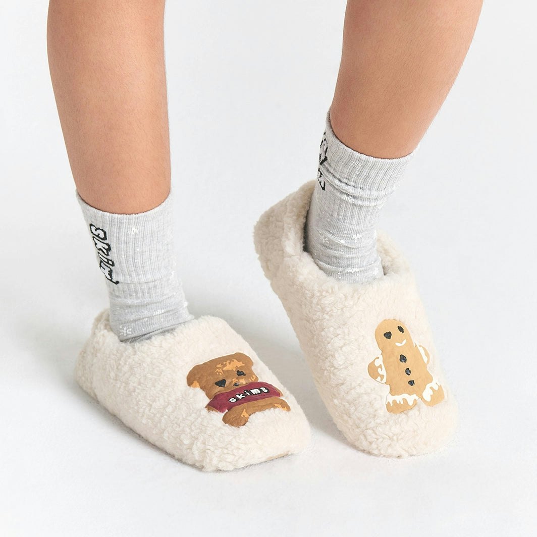 CACTUS PLANT FLEA MARKET X SKIMS SHERPA SLIPPER | MARBLE TEDDY BEAR PRINT ON A MODEL SIDE VIEW FOCUS: 0.0, 1.0, 0.9