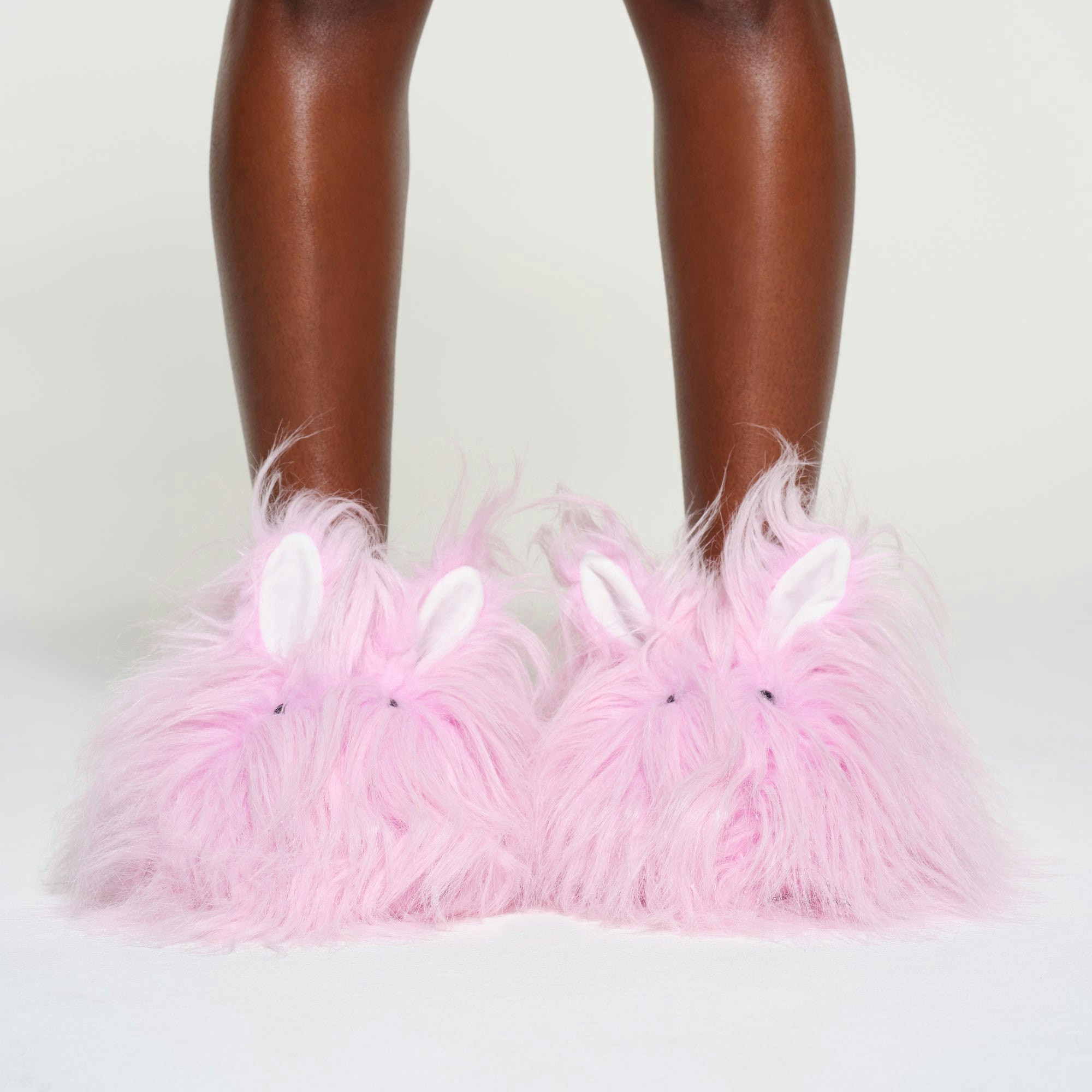 PLUSH BUNNY SLIPPER | BABY PINK ON A MODEL FRONT VIEW