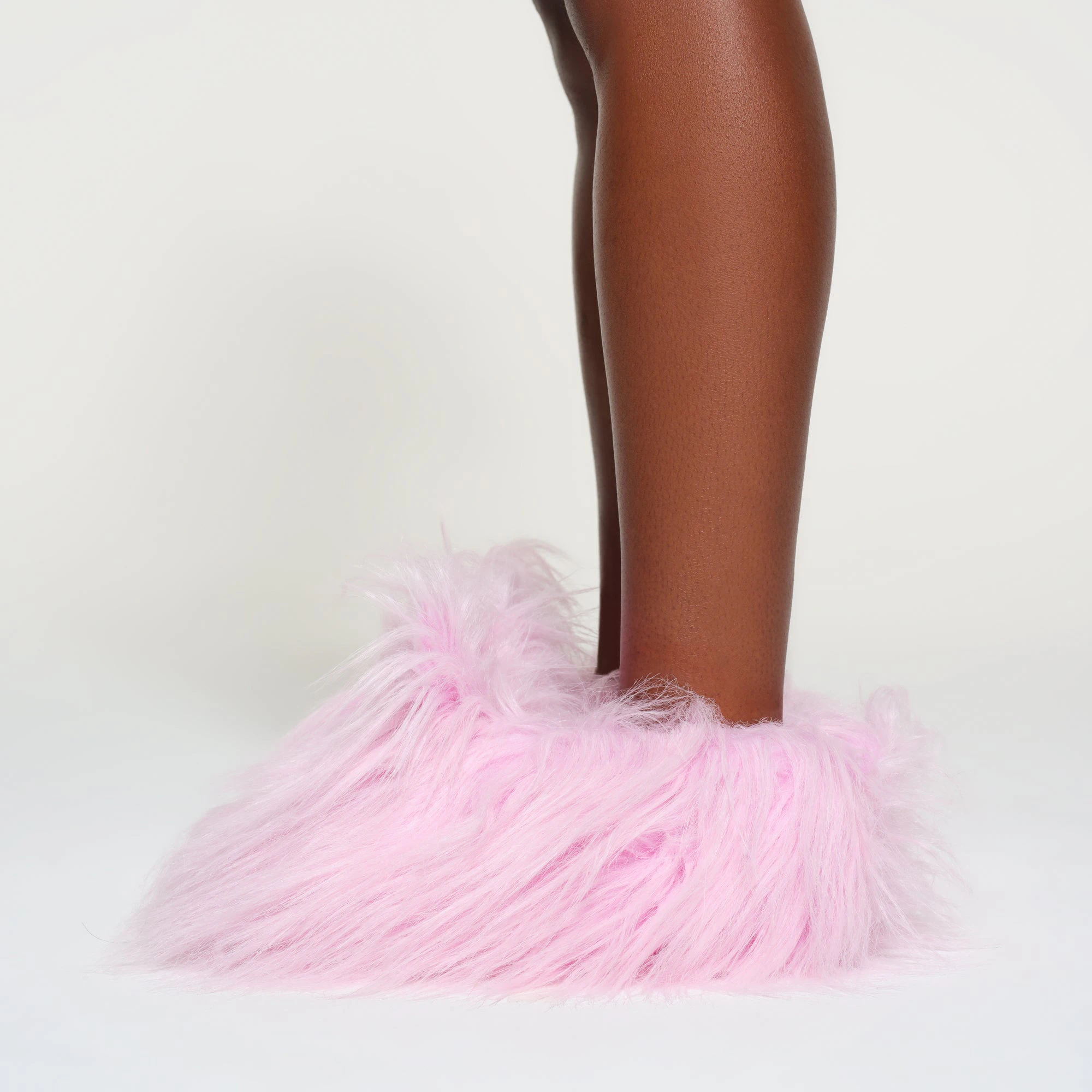 PLUSH BUNNY SLIPPER | BABY PINK ON A MODEL SIDE VIEW
