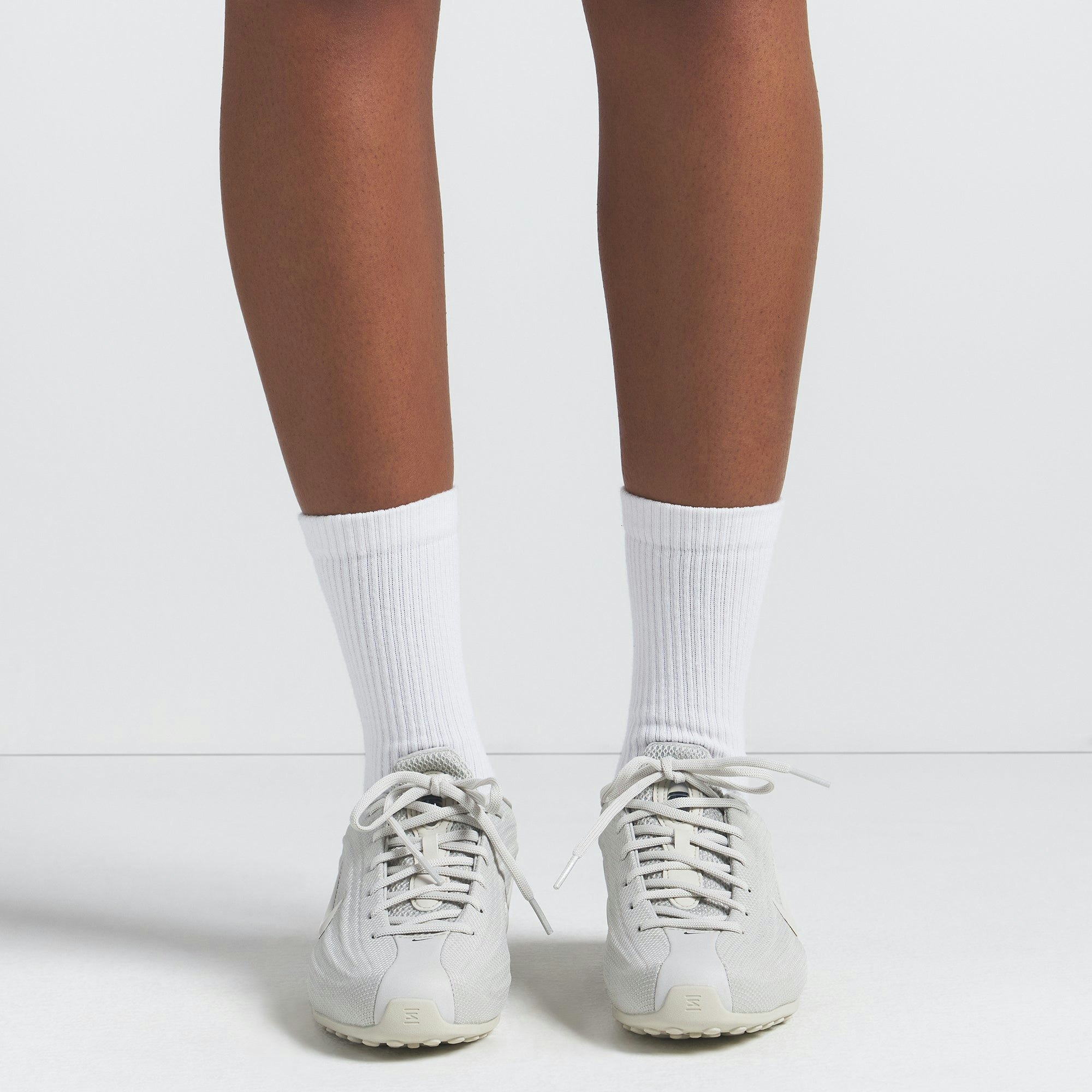 NikeSKIMS DRI-FIT CREW SOCK 3-PACK | SNOW ON A MODEL FRONT VIEW @ | FOCUS: 0.0, 1.0, 0.9