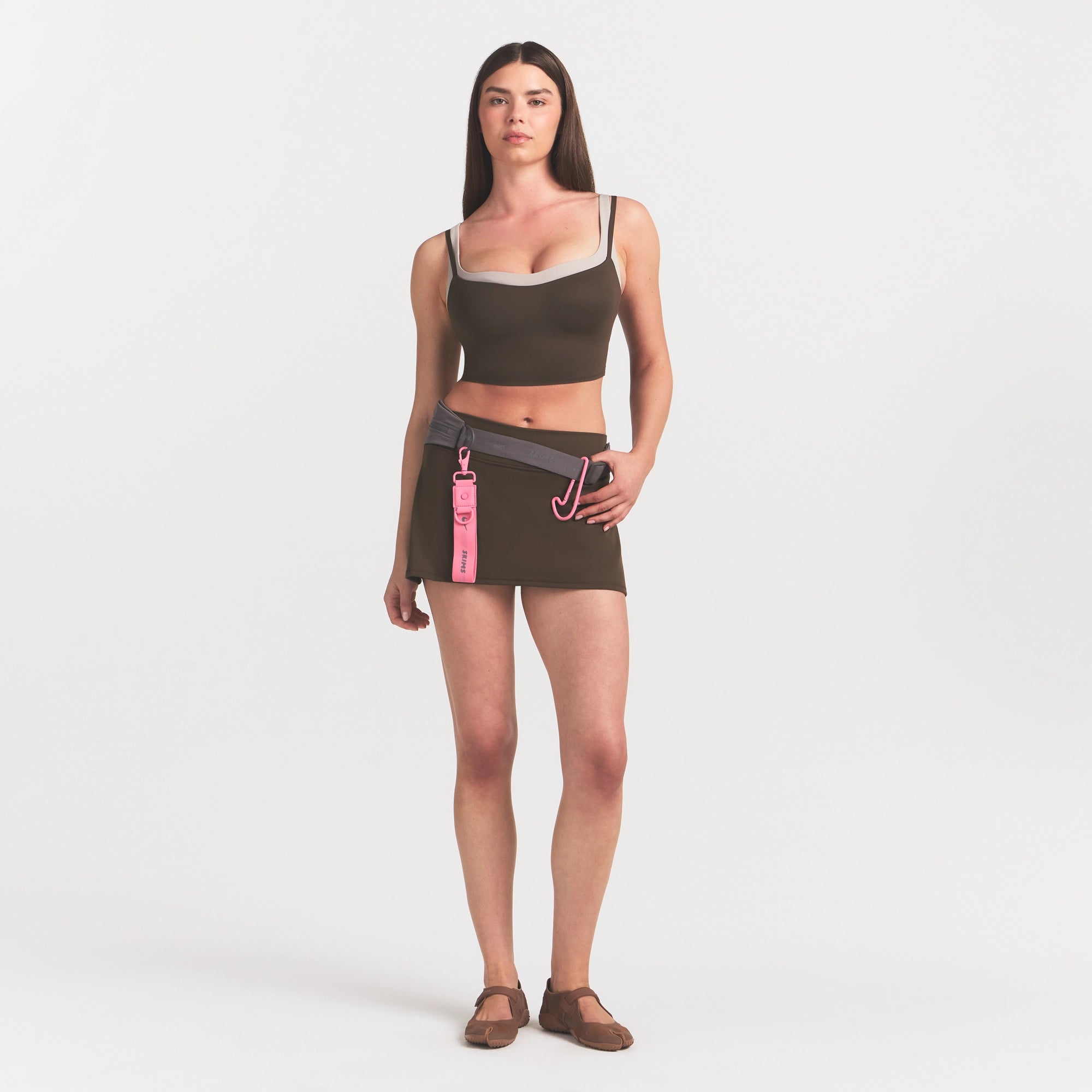 NikeSKIMS MATTE SKORT | NSKM DARK SEPIA ON A MODEL VIEW @ | FOCUS: 0.0, 1.0, 0.9