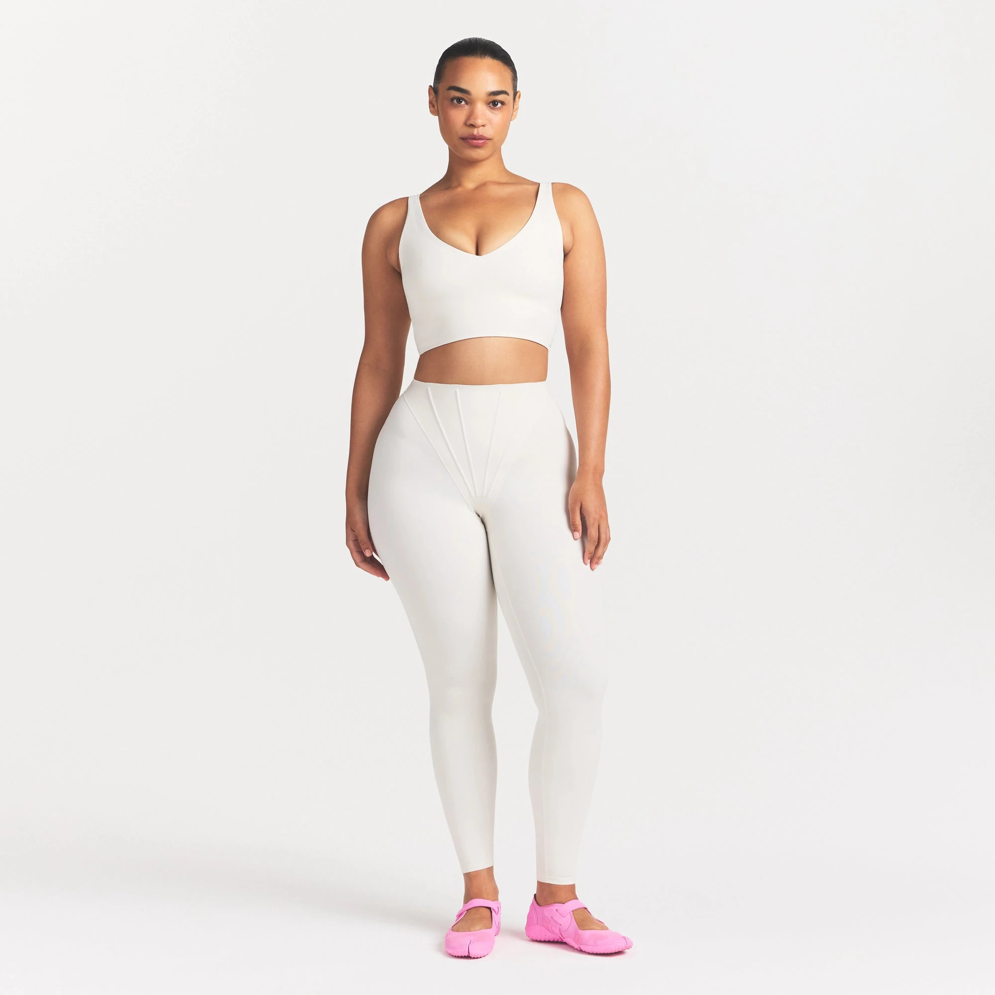 NikeSKIMS MATTE V-NECK BRA TOP | IVORY ON A MODEL