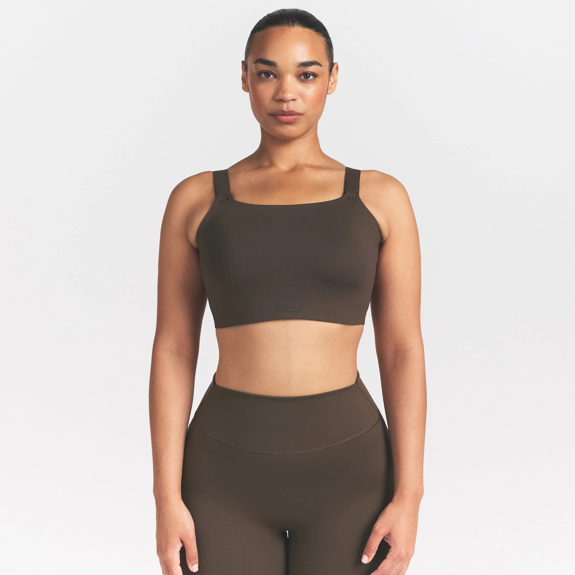NikeSKIMS MATTE WIDE STRAP BRA | DARK SEPIA ON A MODEL FRONT VIEW @ | FOCUS: 0.9, 0.1, 0.7