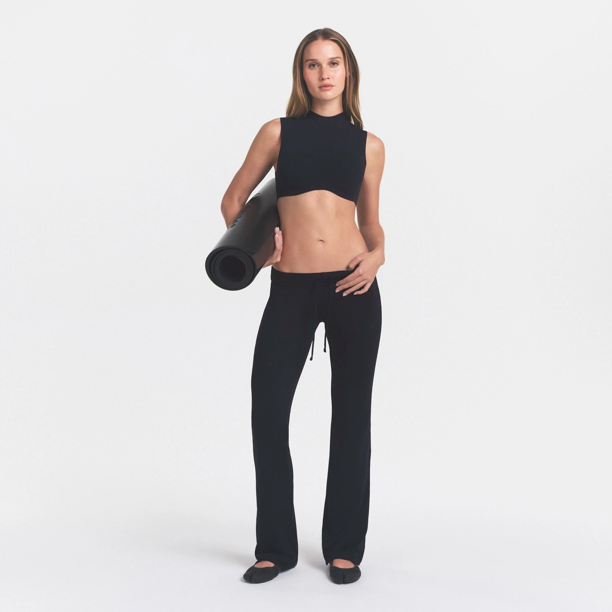 NikeSKIMS AIRY LOW RISE MINI FLARE PANT | NSKM OBSIDIAN ON A MODEL