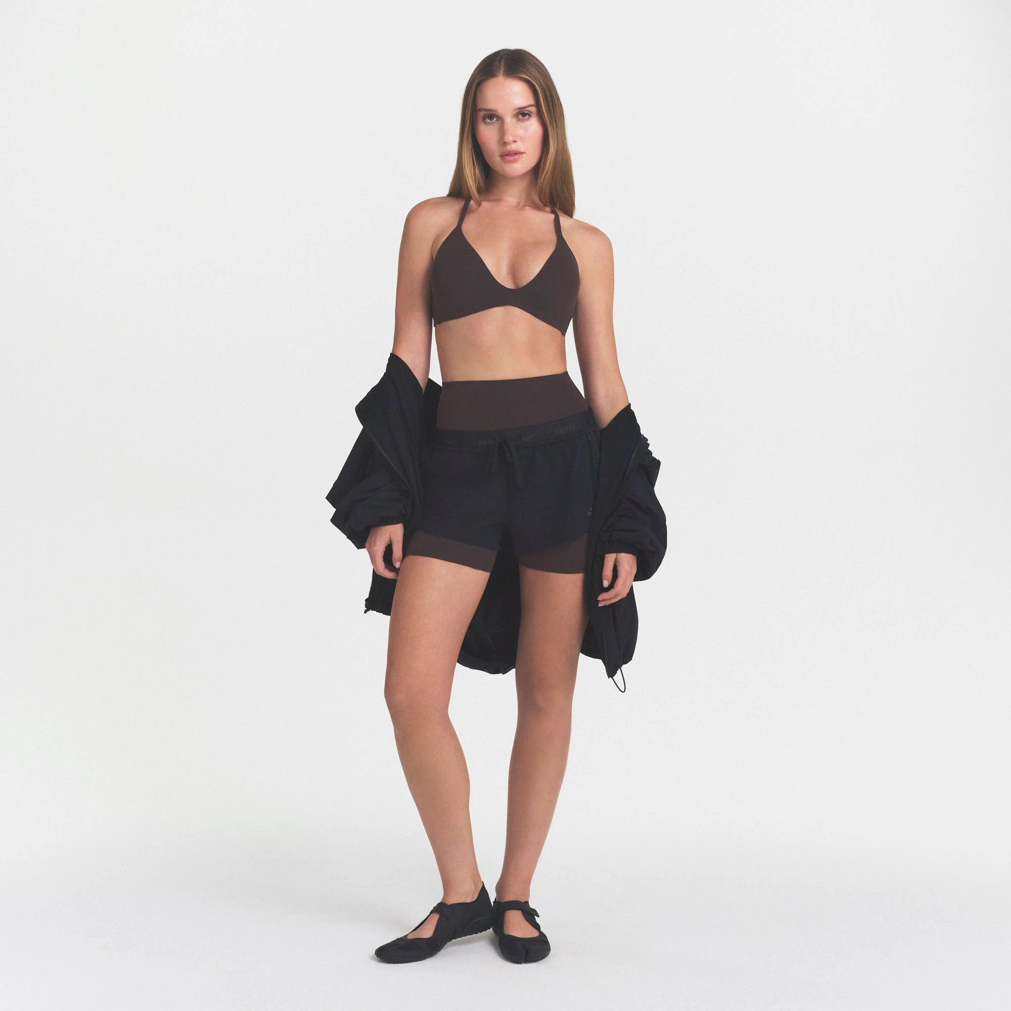 NikeSKIMS STUDIO STRETCH T-BACK TRIANGLE BRA | DARK ROASTON A MODEL FRONT VIEW @ | FOCUS: 0.0, 1.0, 0.9