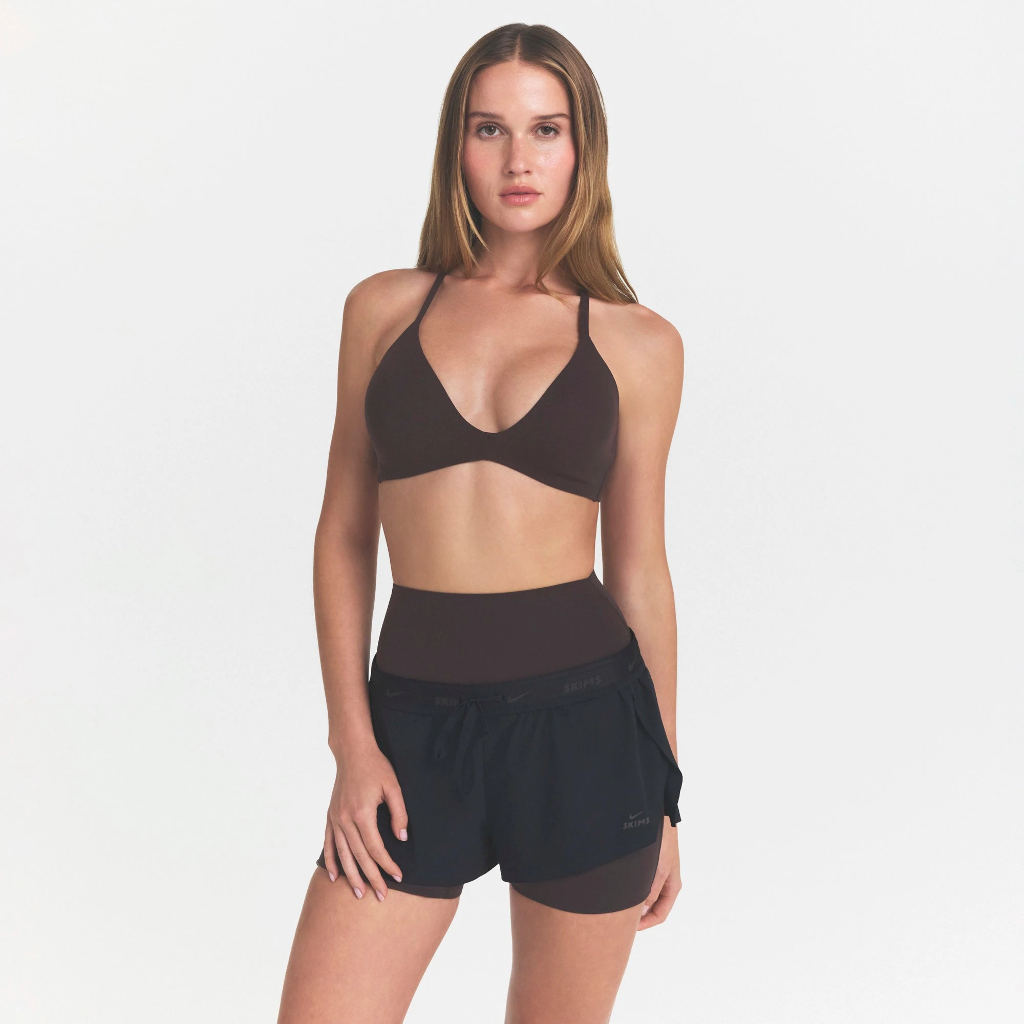 NikeSKIMS STUDIO STRETCH T-BACK TRIANGLE BRA | DARK ROASTON A MODEL FRONT VIEW @ | FOCUS: 0.0, 1.0, 0.9