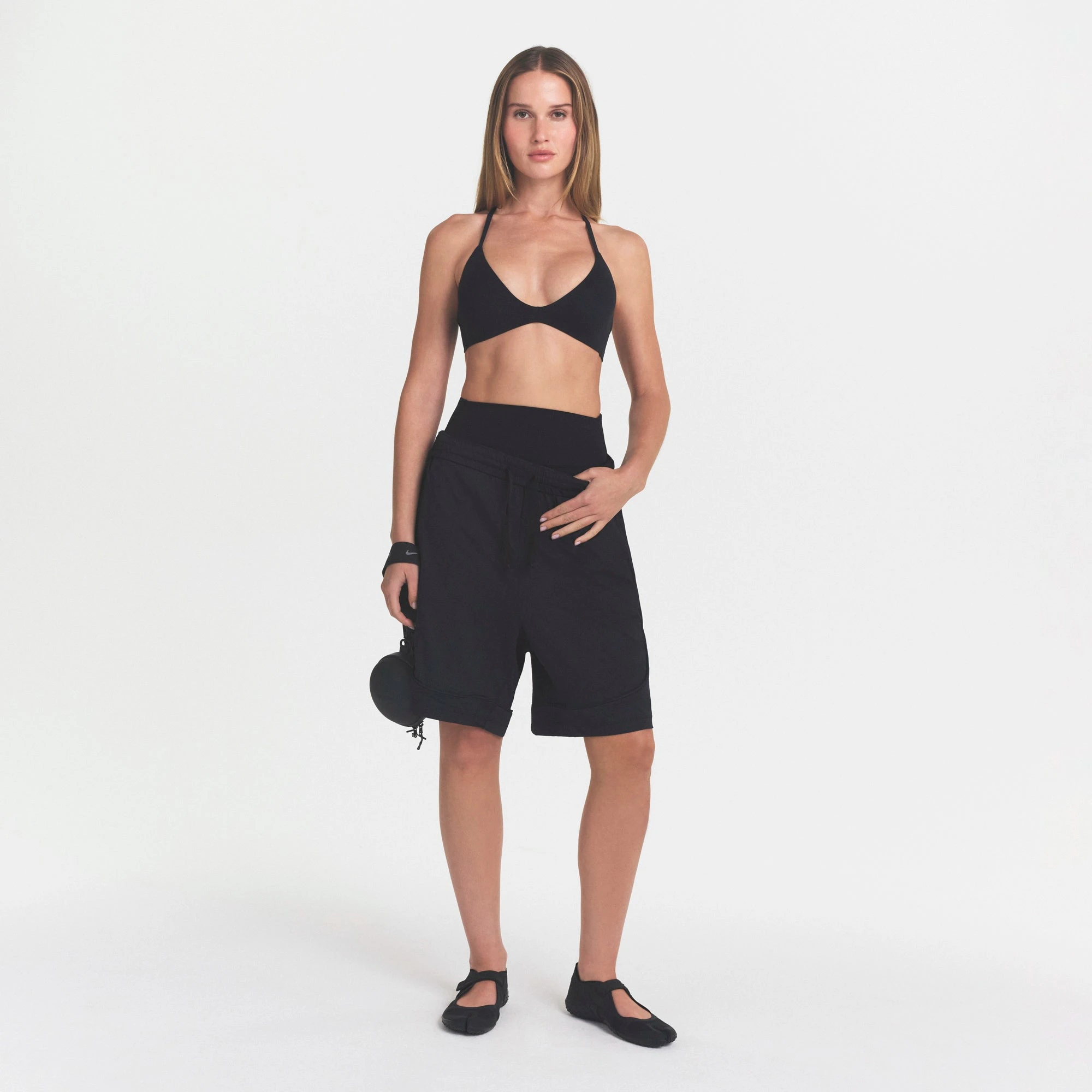 NikeSKIMS STUDIO STRETCH T-BACK TRIANGLE BRA | OBSIDIANON A MODEL FRONT VIEW @ | FOCUS: 0.0, 1.0, 0.9